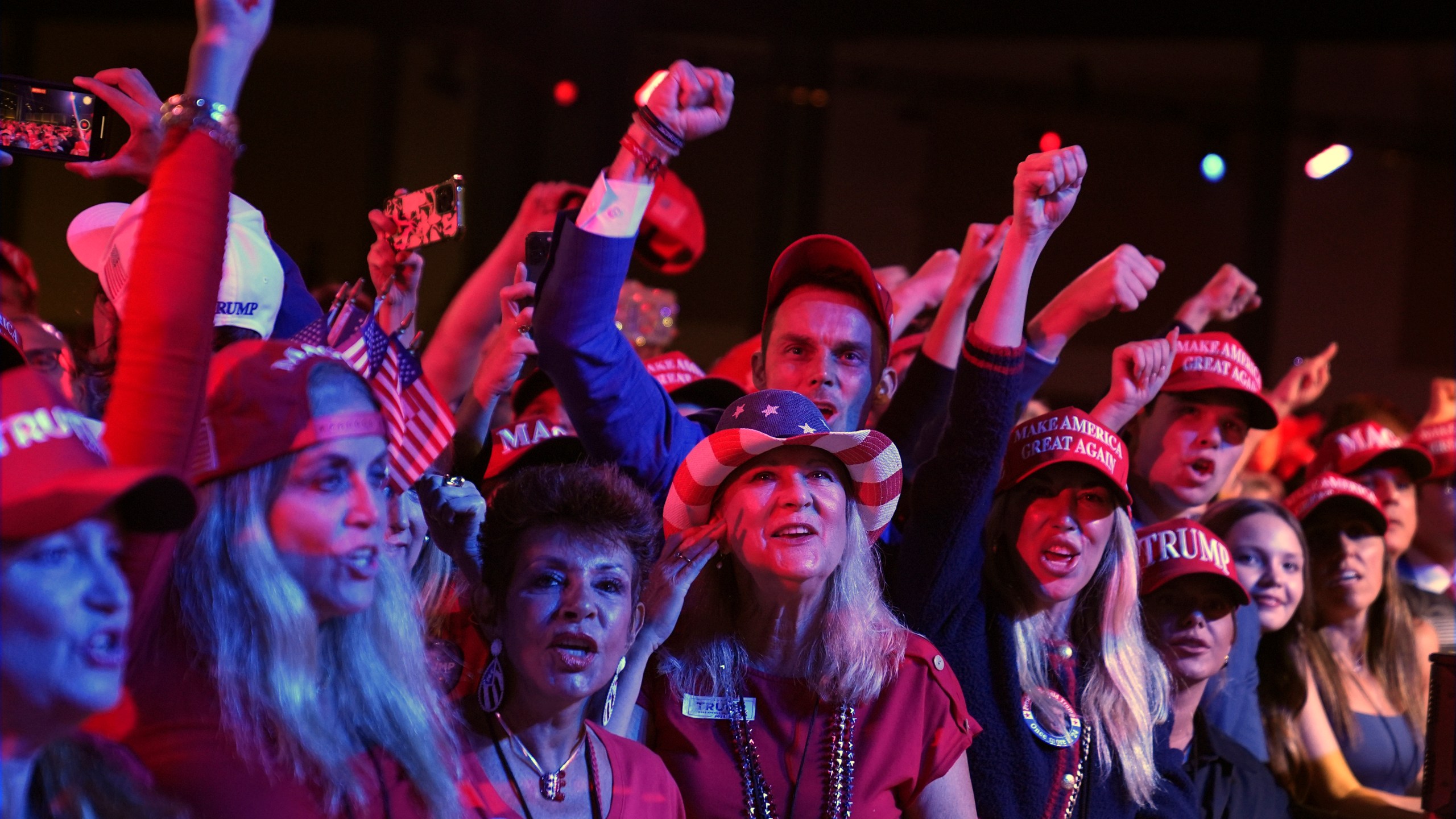 Supporters watch returns at a campaign election night watch party for Republican presidential nominee former President Donald Trump at the Palm Beach Convention Center, Wednesday, Nov. 6, 2024, in West Palm Beach, Fla. (AP Photo/Evan Vucci)