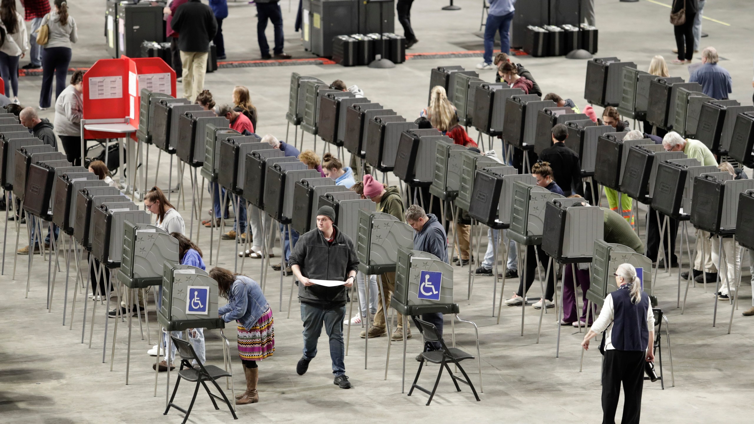 Voters fill out their ballots on Election Day Tuesday, Nov. 5, 2024, at the Cross Insurance Center in Bangor, Maine. (AP Photo/Joel Page)