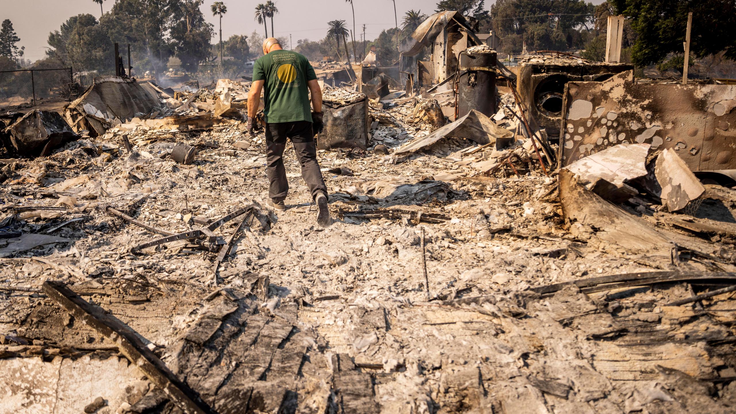 Marvin Meador walks on the remains of his fire-ravaged property after the Mountain Fire swept through, Thursday, Nov. 7, 2024, in Camarillo, Calif. (AP Photo/Ethan Swope)