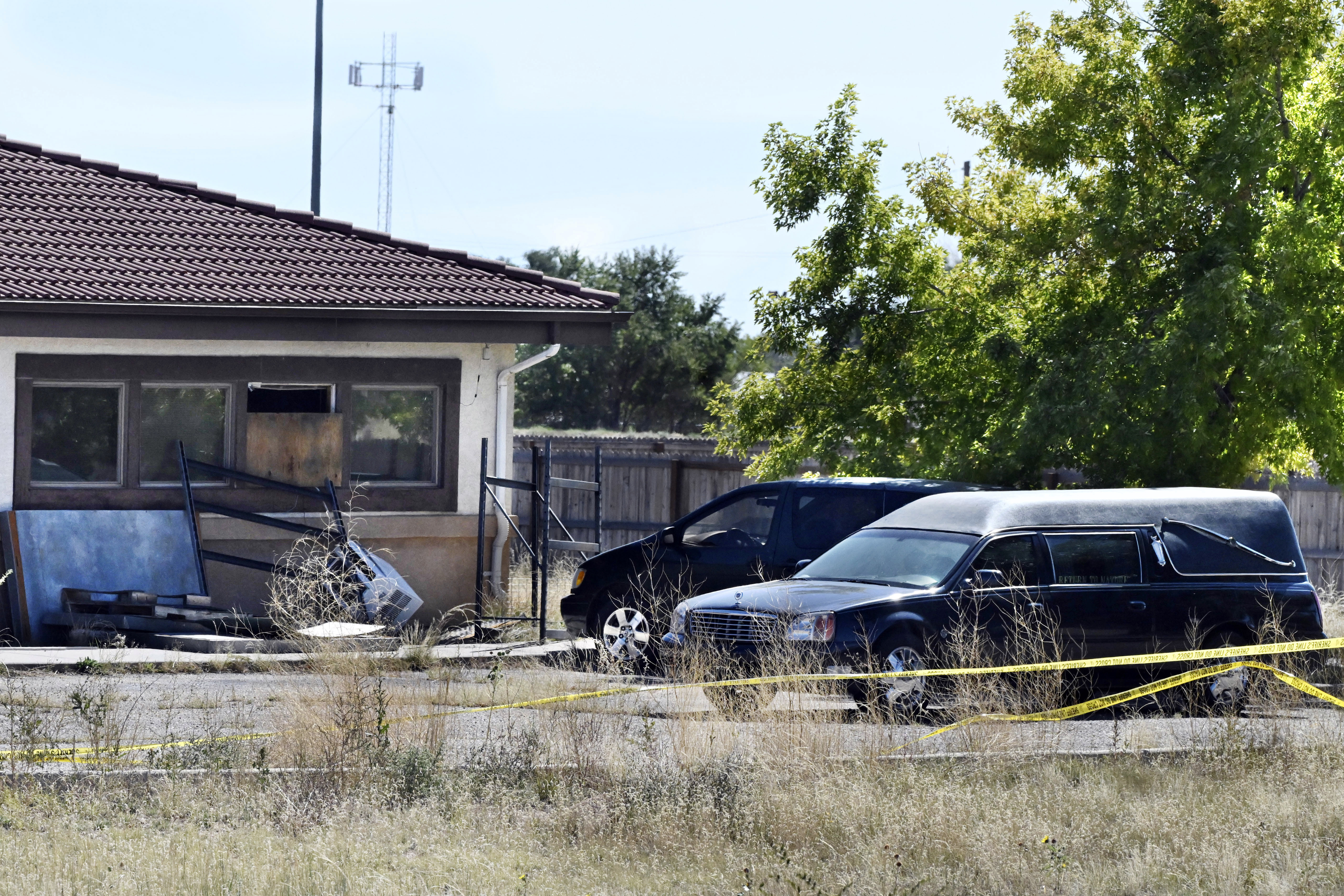 FILE - A hearse and debris can be seen at the rear of the Return to Nature Funeral Home, Oct. 5, 2023, in Penrose, Colo. (Jerilee Bennett/The Gazette via AP, File)