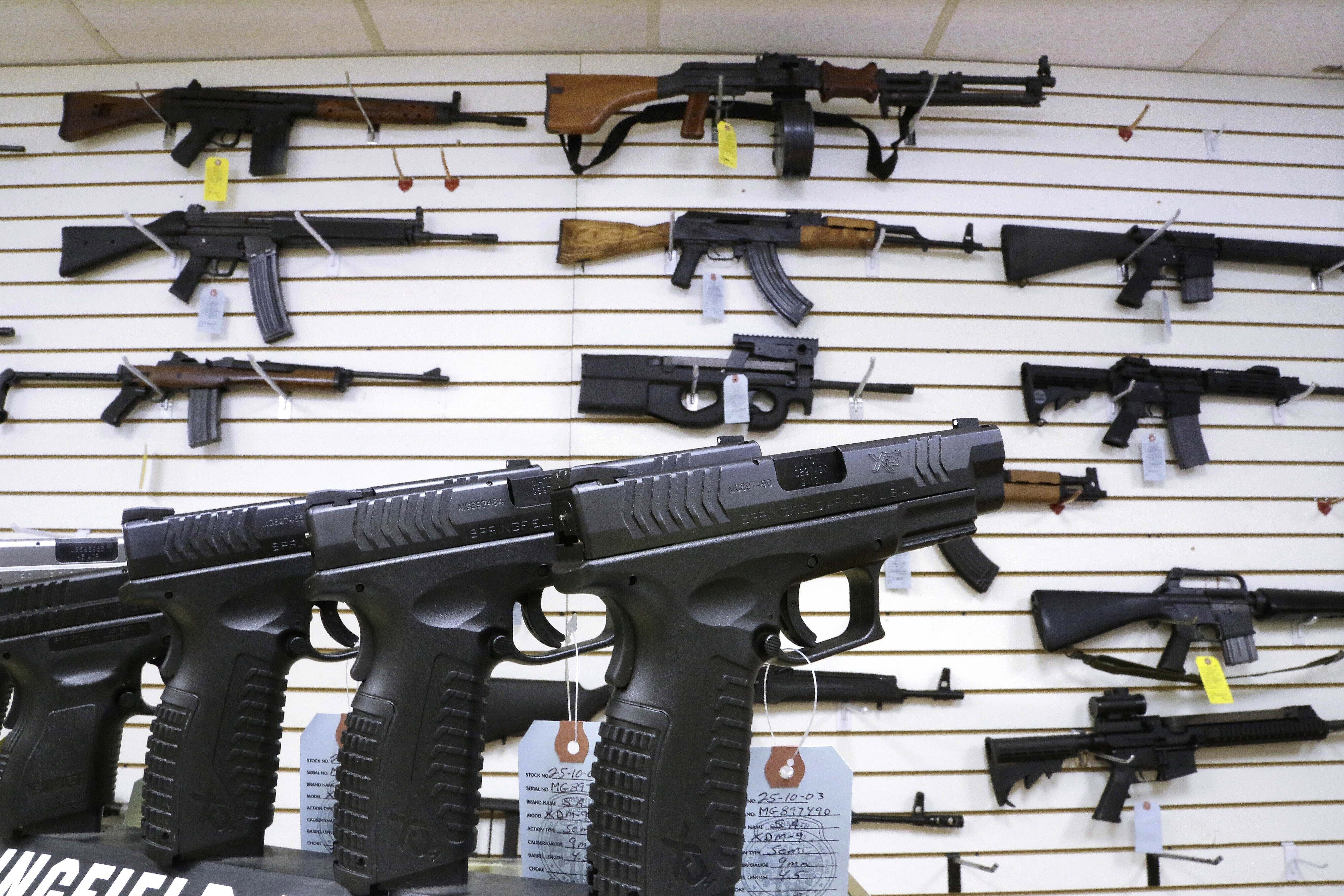 FILE - Assault style weapons and hand guns are displayed for sale at Capitol City Arms Supply on Jan. 16, 2013, in Springfield, Ill. (AP Photo/Seth Perlman, File)