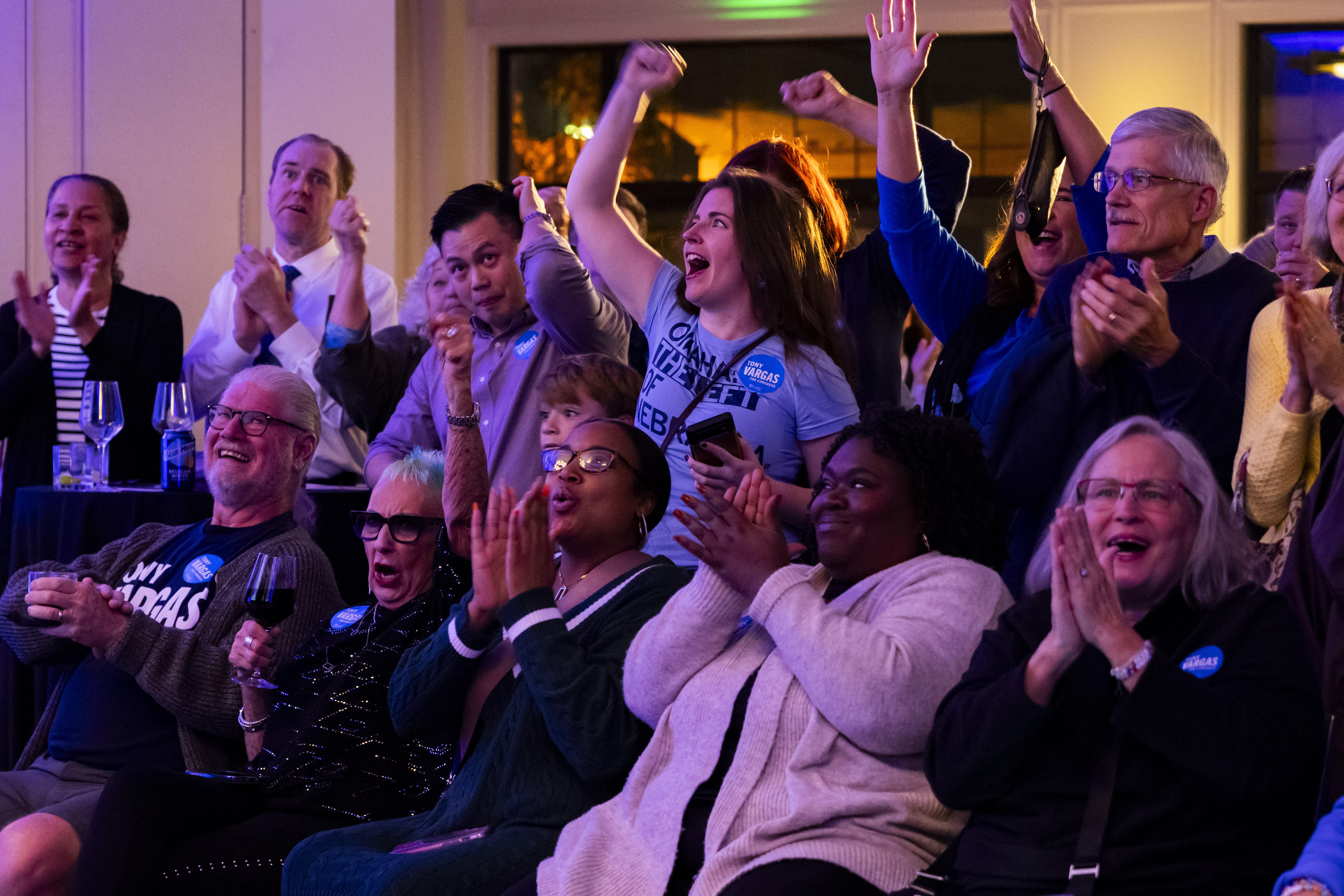 Attendees cheer as the first results shown show state Sen. Tony Vargas leading over U.S. Rep. Don Bacon during an election night watch party for Vargas, Tuesday, Nov. 5, 2024, at the Kimpton Cottonwood Hotel in Omaha, Neb.(Megan Nielsen/Omaha World-Herald via AP)