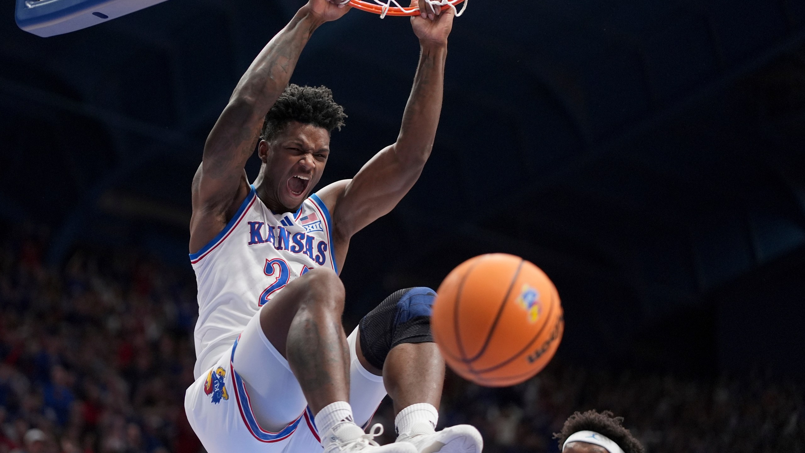 Kansas forward KJ Adams Jr. dunks the ball during the first half of an NCAA college basketball game against North Carolina Friday, Nov. 8, 2024, in Lawrence, Kan. (AP Photo/Charlie Riedel)