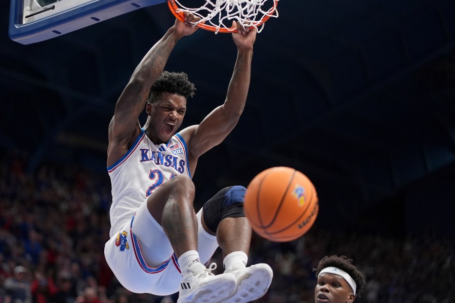 Kansas forward KJ Adams Jr. dunks the ball during the first half of an NCAA college basketball game against North Carolina Friday, Nov. 8, 2024, in Lawrence, Kan. (AP Photo/Charlie Riedel)