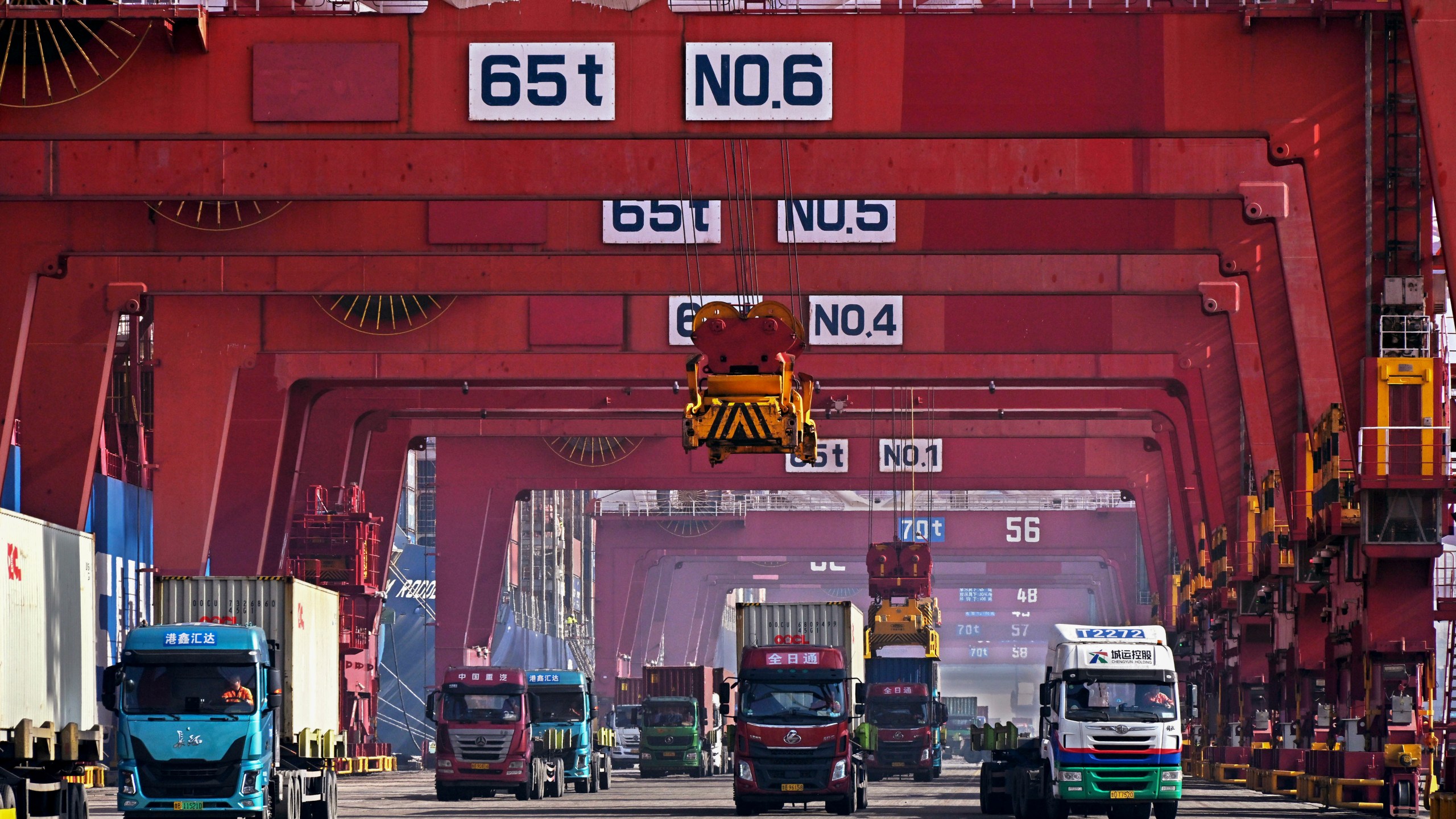 FILE - In this photo released by Xinhua News Agency, containers are unloaded from a cargo ship at Qingdao Port, east China's Shandong Province on Feb.11, 2024. (Li Ziheng/Xinhua via AP, File)