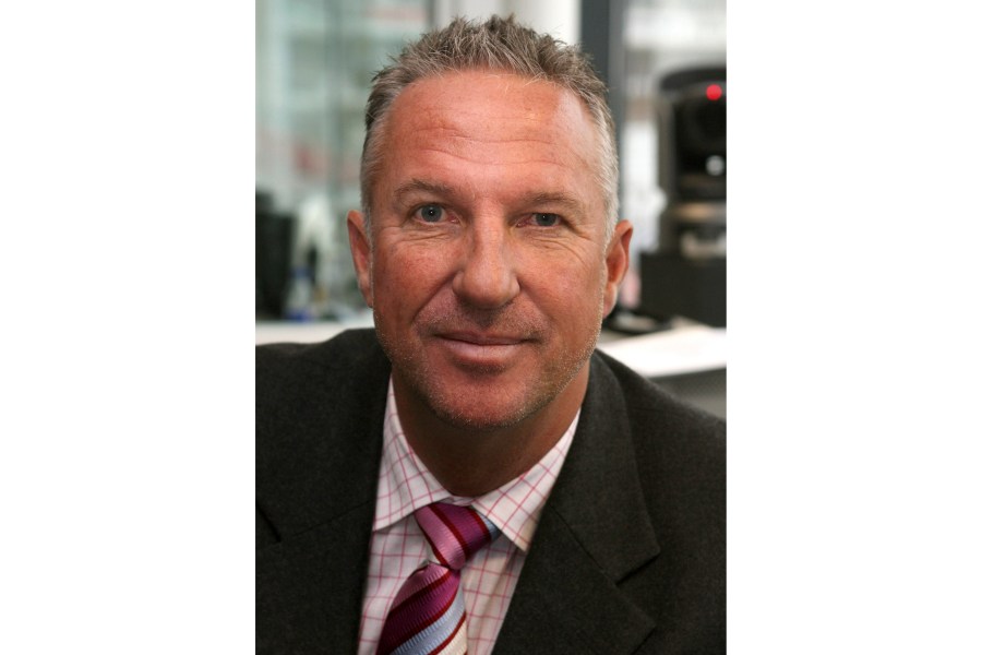 FILE - Former England cricketer Ian Botham prepares to commentate on the first day of England's fourth Test match of their four Test series against the West Indies in Durham, England on June 15, 2007 (AP Photo/Jon Super, File)