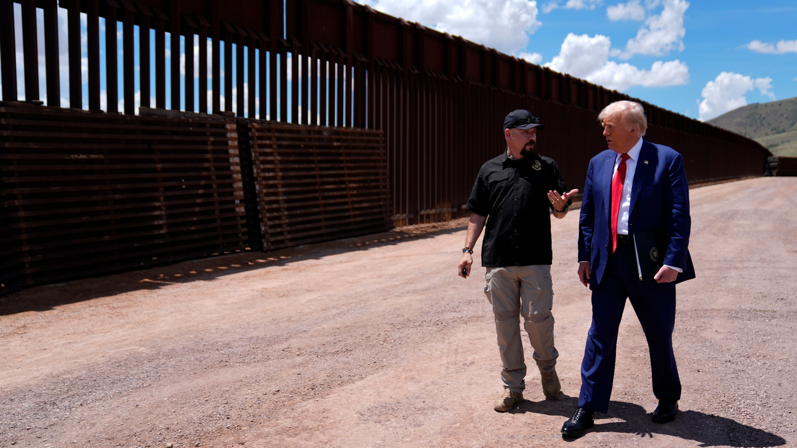 FILE - Republican presidential nominee former President Donald Trump listens to Paul Perez, president of the National Border Patrol Council, as he tours the southern border with Mexico, on Aug. 22, 2024, in Sierra Vista, Ariz. (AP Photo/Evan Vucci)