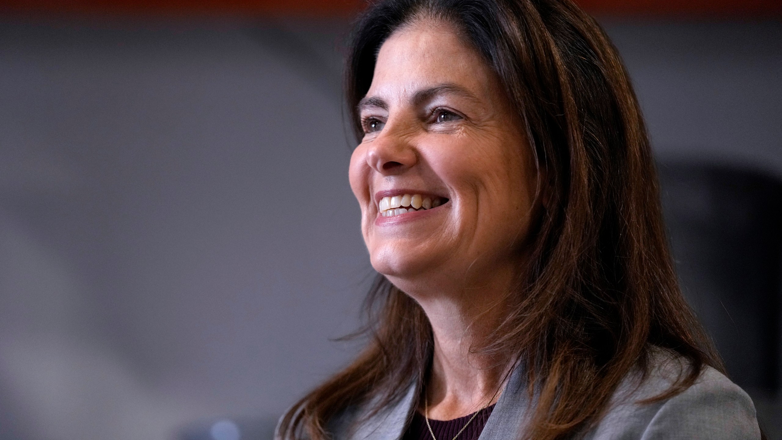 FILE - Republican gubernatorial candidate Kelly Ayotte, who faces Democrat Joyce Craig in the November 2024 election, smiles during a visit to a local concrete coating business, Wednesday, Oct. 16, 2024, in Manchester, N.H. (AP Photo/Charles Krupa, File)