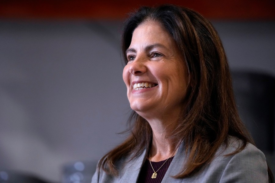 FILE - Republican gubernatorial candidate Kelly Ayotte, who faces Democrat Joyce Craig in the November 2024 election, smiles during a visit to a local concrete coating business, Wednesday, Oct. 16, 2024, in Manchester, N.H. (AP Photo/Charles Krupa, File)