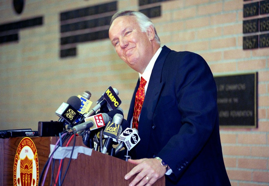 FILE - Former head coach of the Los Angeles Rams John Robinson addresses the media in Los Angeles, Jan. 3, 1992. (AP Photo/Chris Martinez, File)