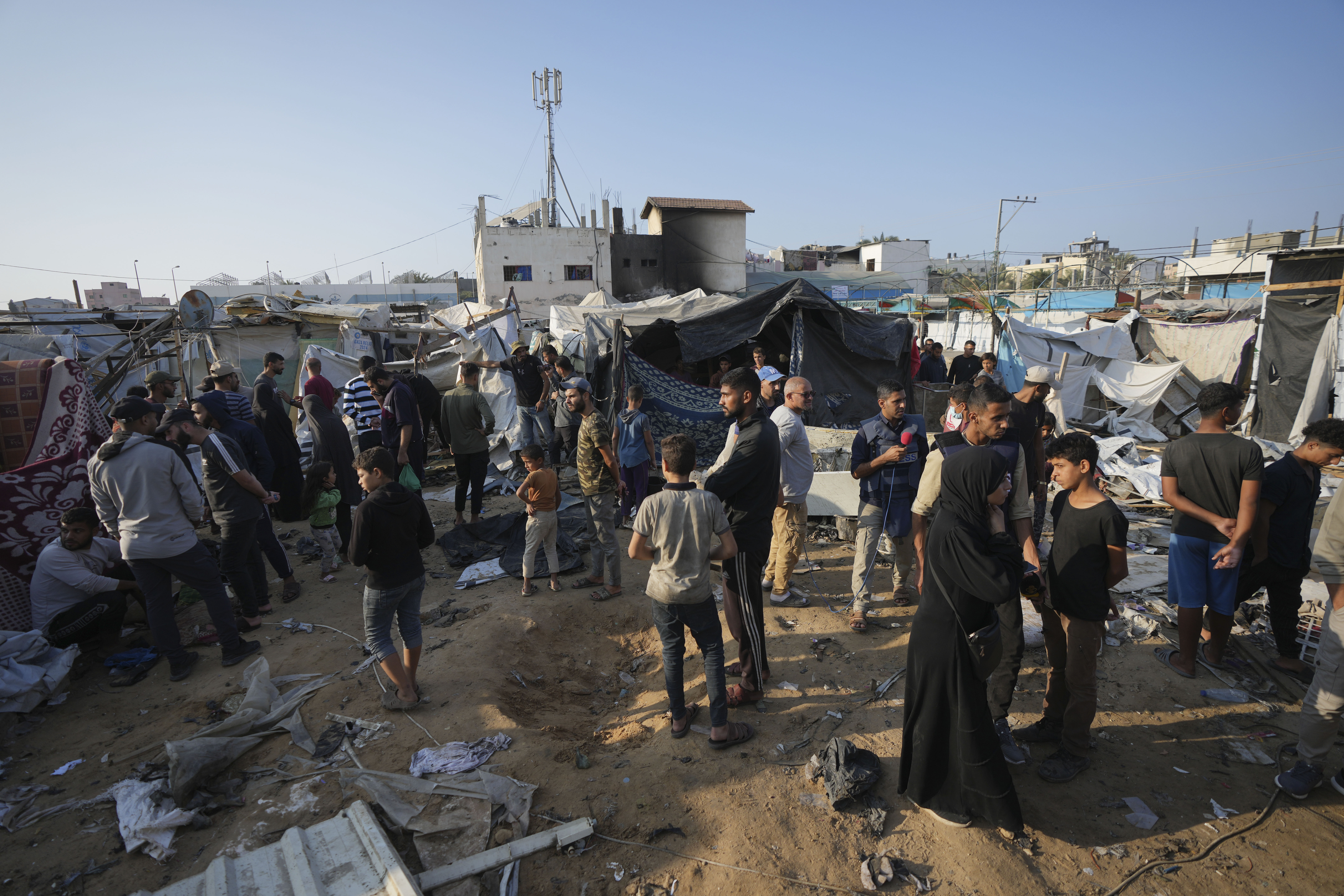 FILE - Palestinians gather at the site of an Israeli strike in the courtyard of the Al-Aqsa Hospital where displaced people live in tents, in Deir al-Balah, Gaza Strip, on Nov. 9, 2024. (AP Photo/Abdel Kareem Hana, File)