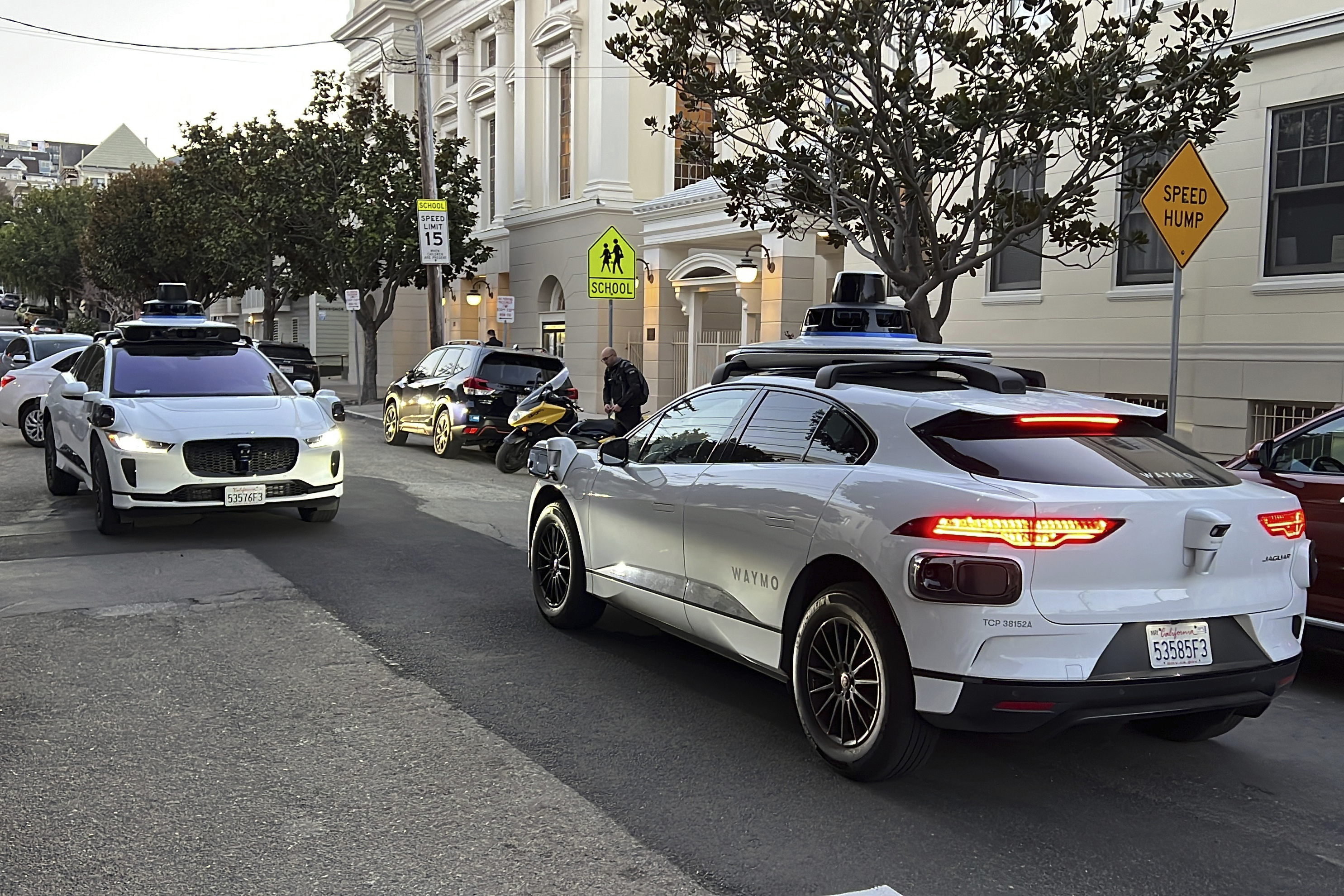 FILE - Two Waymo driverless taxis stop before passing one another on a San Francisco street on Feb. 15, 2023. (AP Photo/Terry Chea, File)