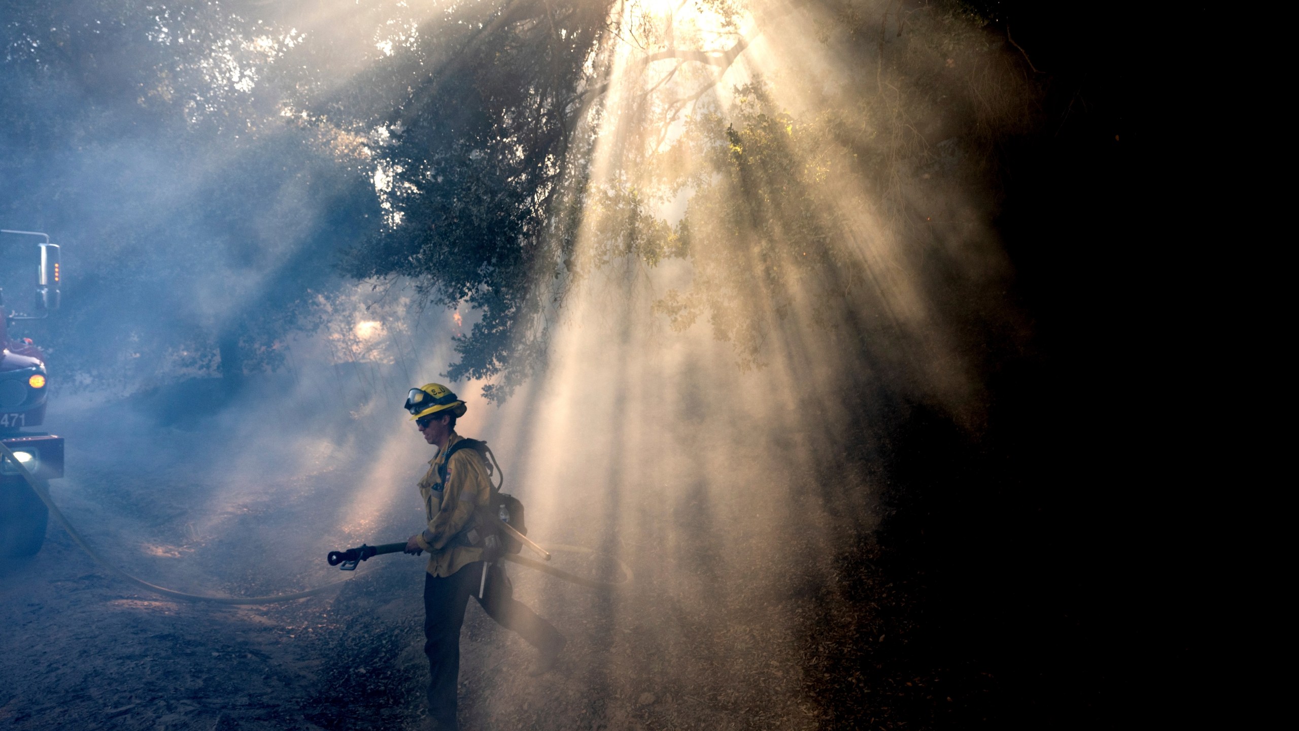 FILE - A firefighter walks through smoke while battling the Mountain Fire, Nov. 7, 2024, in Santa Paula, Calif. (AP Photo/Noah Berger,File)