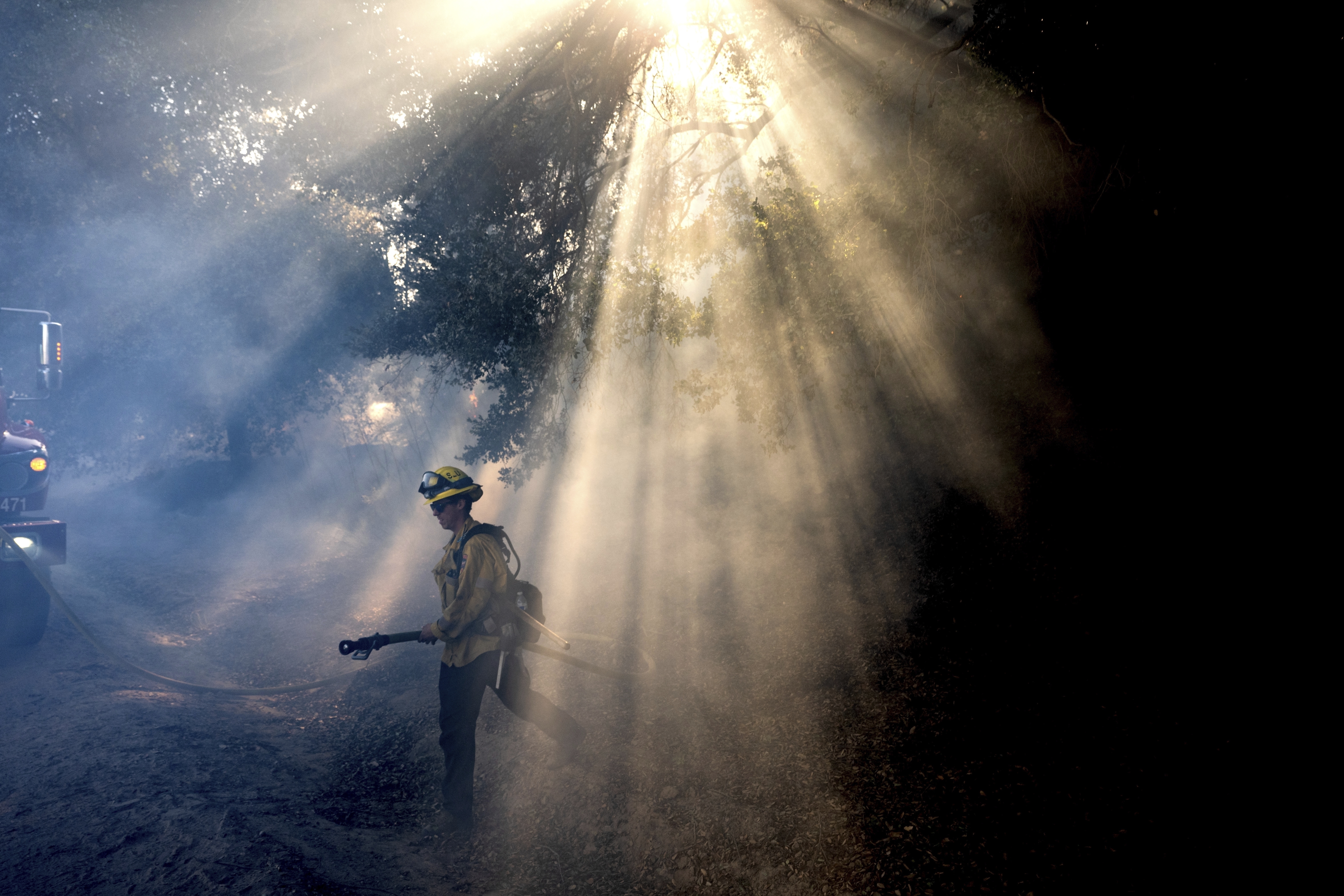 FILE - A firefighter walks through smoke while battling the Mountain Fire, Nov. 7, 2024, in Santa Paula, Calif. (AP Photo/Noah Berger,File)