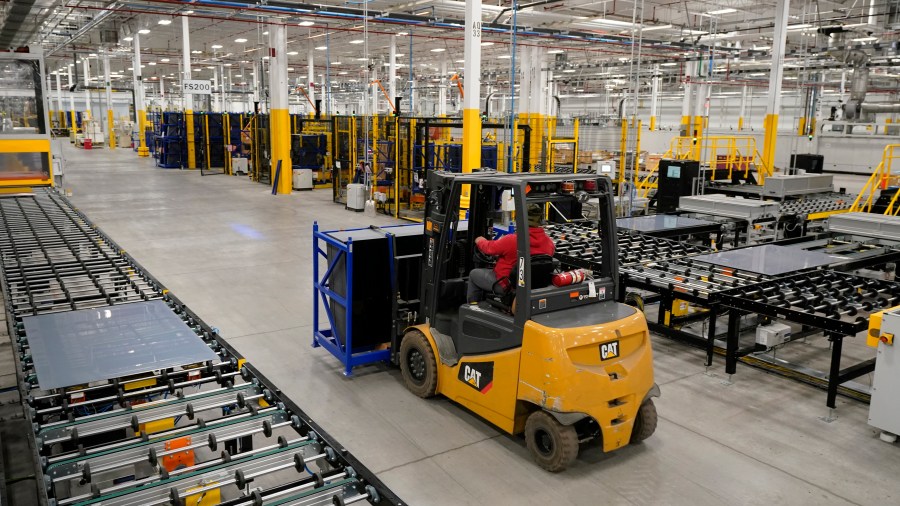 FILE - Solar panels are moved at the First Solar manufacturing plant on Oct. 6, 2021, in Walbridge, Ohio. (AP Photo/Tony Dejak)