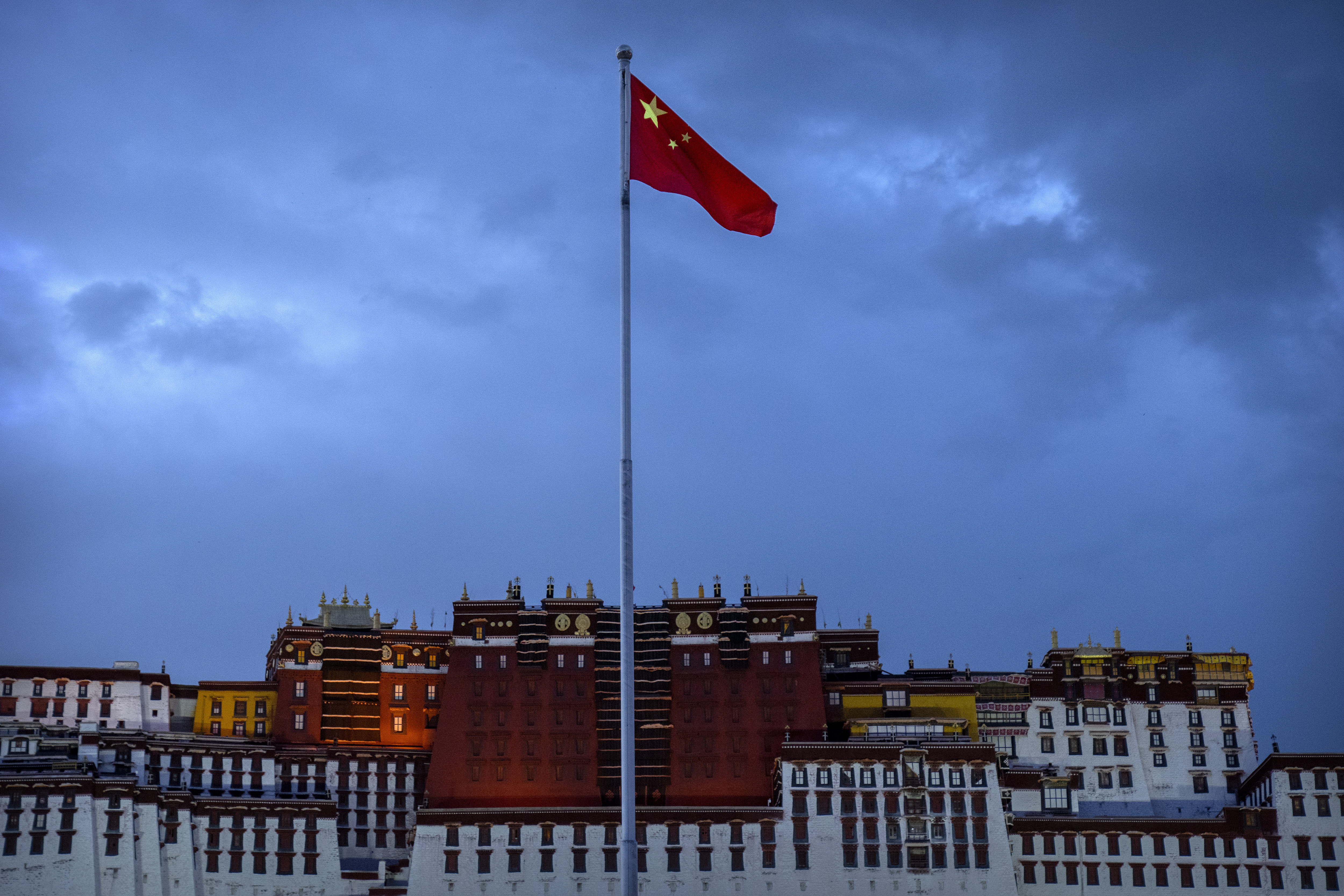 FILE- The Chinese flag flies at a plaza near the Potala Palace in Lhasa in western China's Tibet Autonomous Region, June 1, 2021, as seen during a government organized visit for foreign journalists. (AP Photo/Mark Schiefelbein, File)