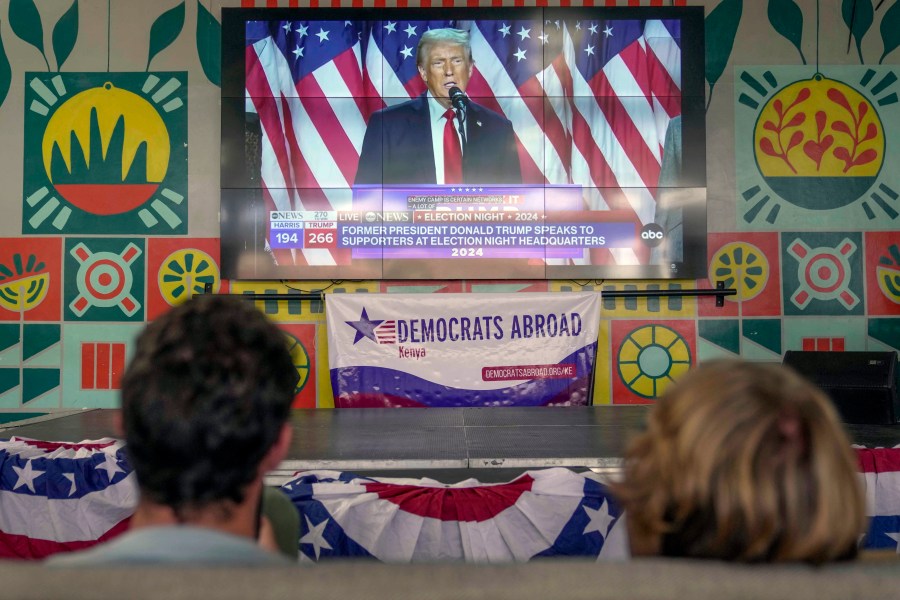 FILE- A screen shows live footage of Republican presidential nominee former President Donald Trump speech during a news program in Nairobi, Kenya, Wednesday, Nov. 6, 2024. (AP Photo/Brian Inganga, file)