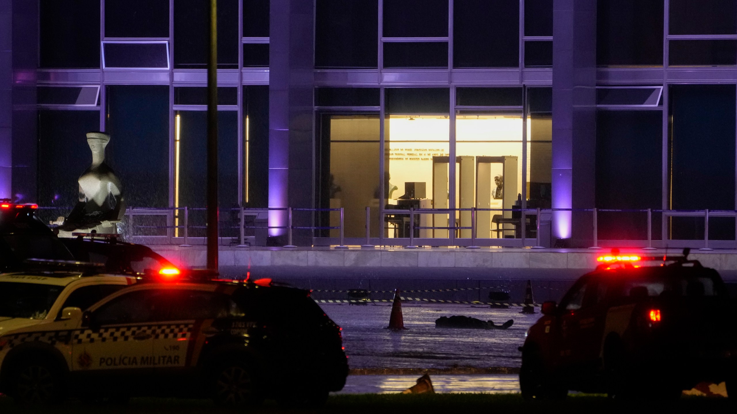 A body lies outside the Supreme Court in Brasília, Brazil, following an explosion, Wednesday, Nov. 13, 2024. (AP Photo/Eraldo Peres)