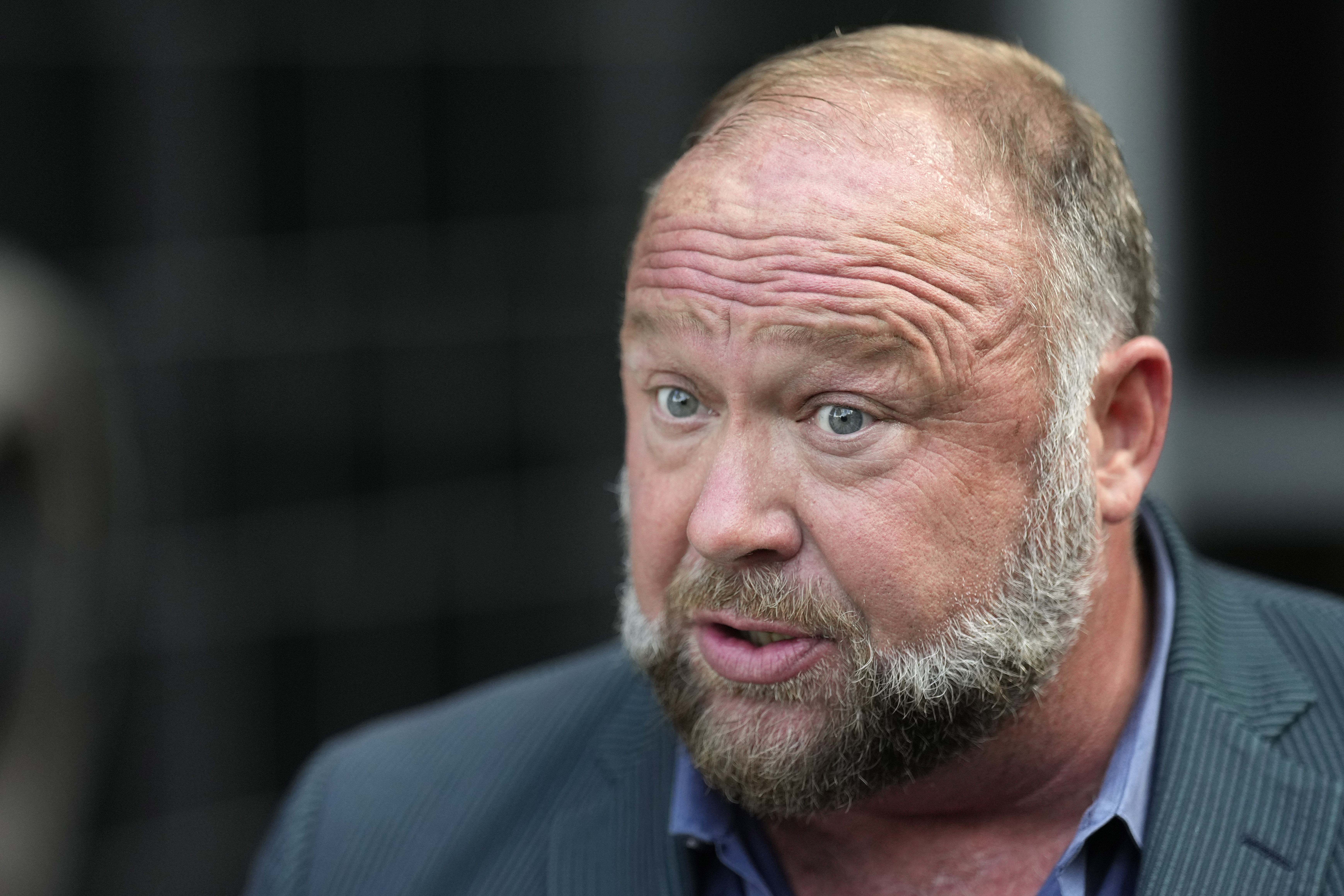 FILE - Right-wing conspiracy theorist Alex Jones speaks to the media after arriving at the federal courthouse for a hearing in front of a bankruptcy judge Friday, June 14, 2024, in Houston. (AP Photo/David J. Phillip, File)