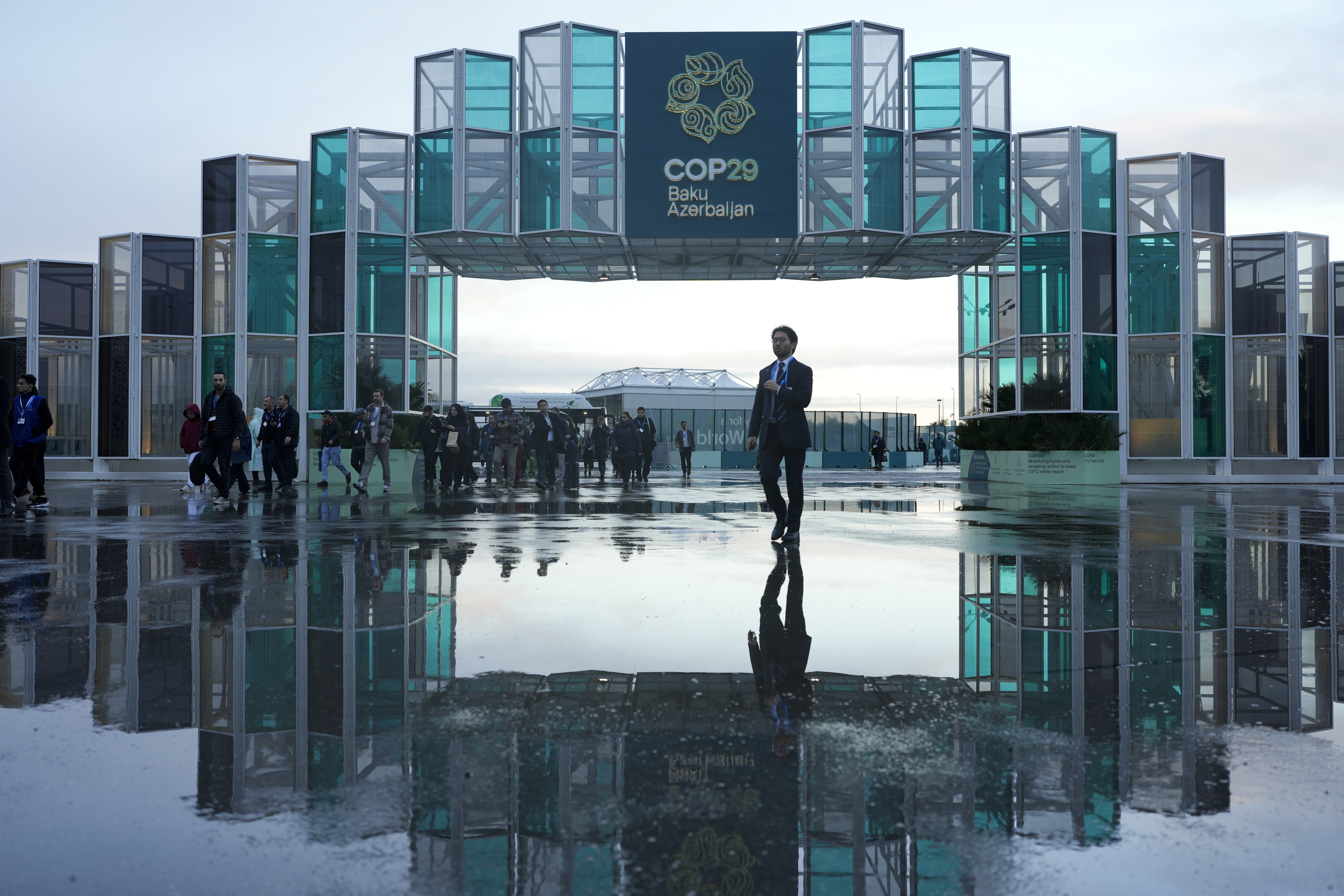 Attendees arrive for the day at the COP29 U.N. Climate Summit, Thursday, Nov. 14, 2024, in Baku, Azerbaijan. (AP Photo/Rafiq Maqbool)