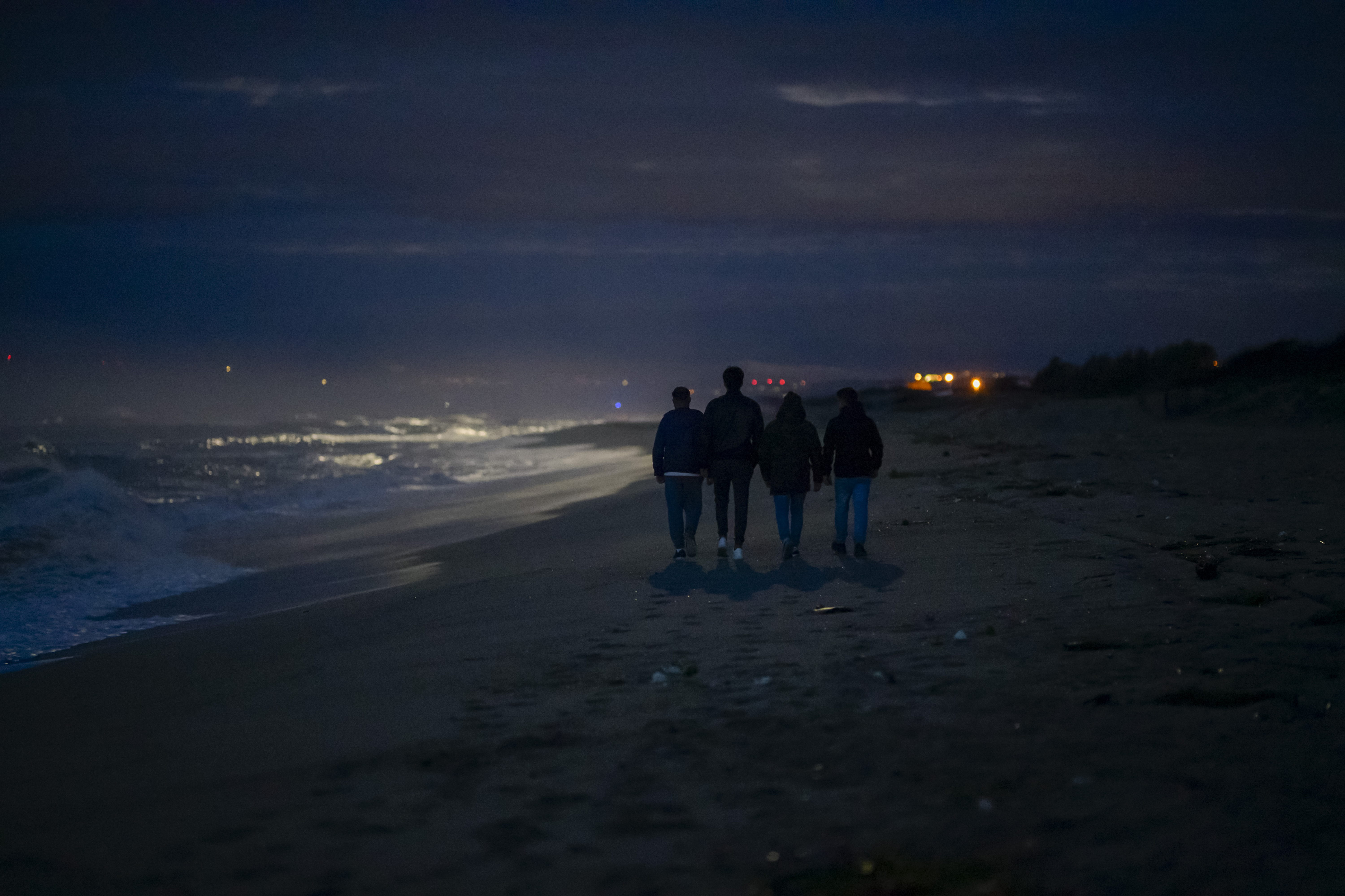 FILE - Survivors and relatives of victims walk, Feb. 26, 2024, at the site where a migrant boat capsized a year earlier in Steccato di Cutro, on the Italian southern tip. AP Photo/Valeria Ferraro, File)