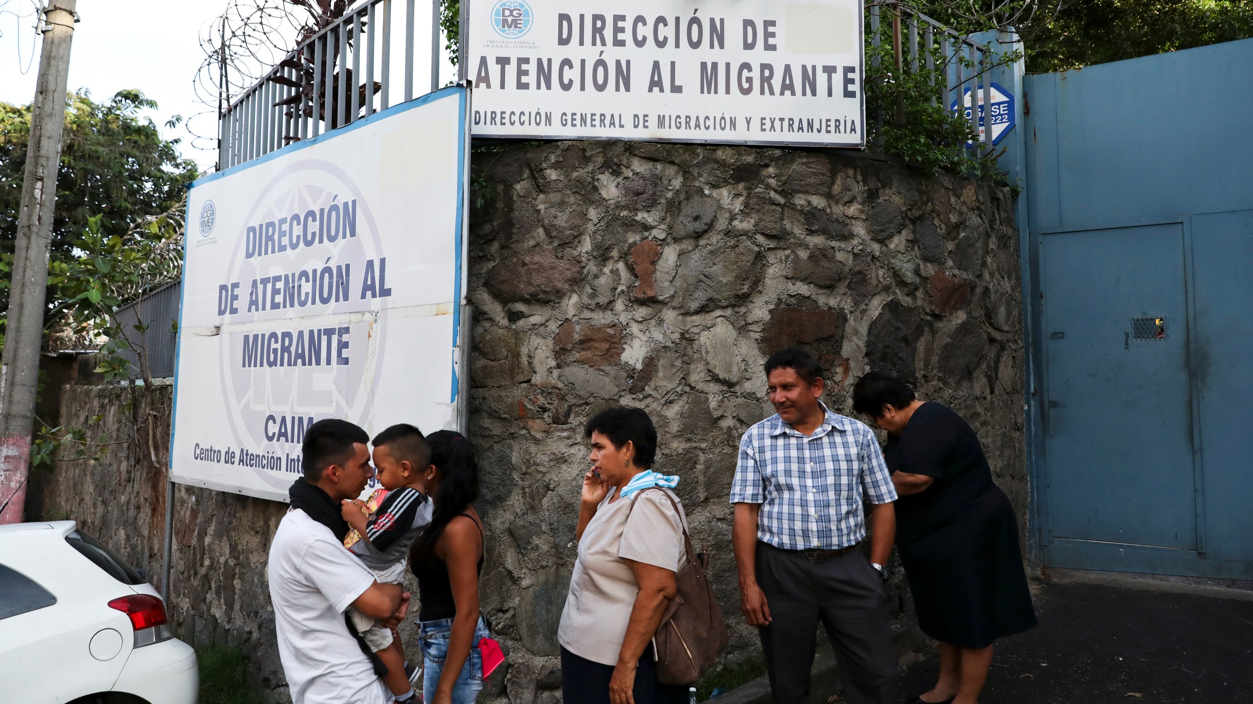 FILE - People gather outside the Migrant Assistance Office on Oct. 9, 2019 in San Salvador, El Salvador. (AP Photo/Eduardo Verdugo, File)