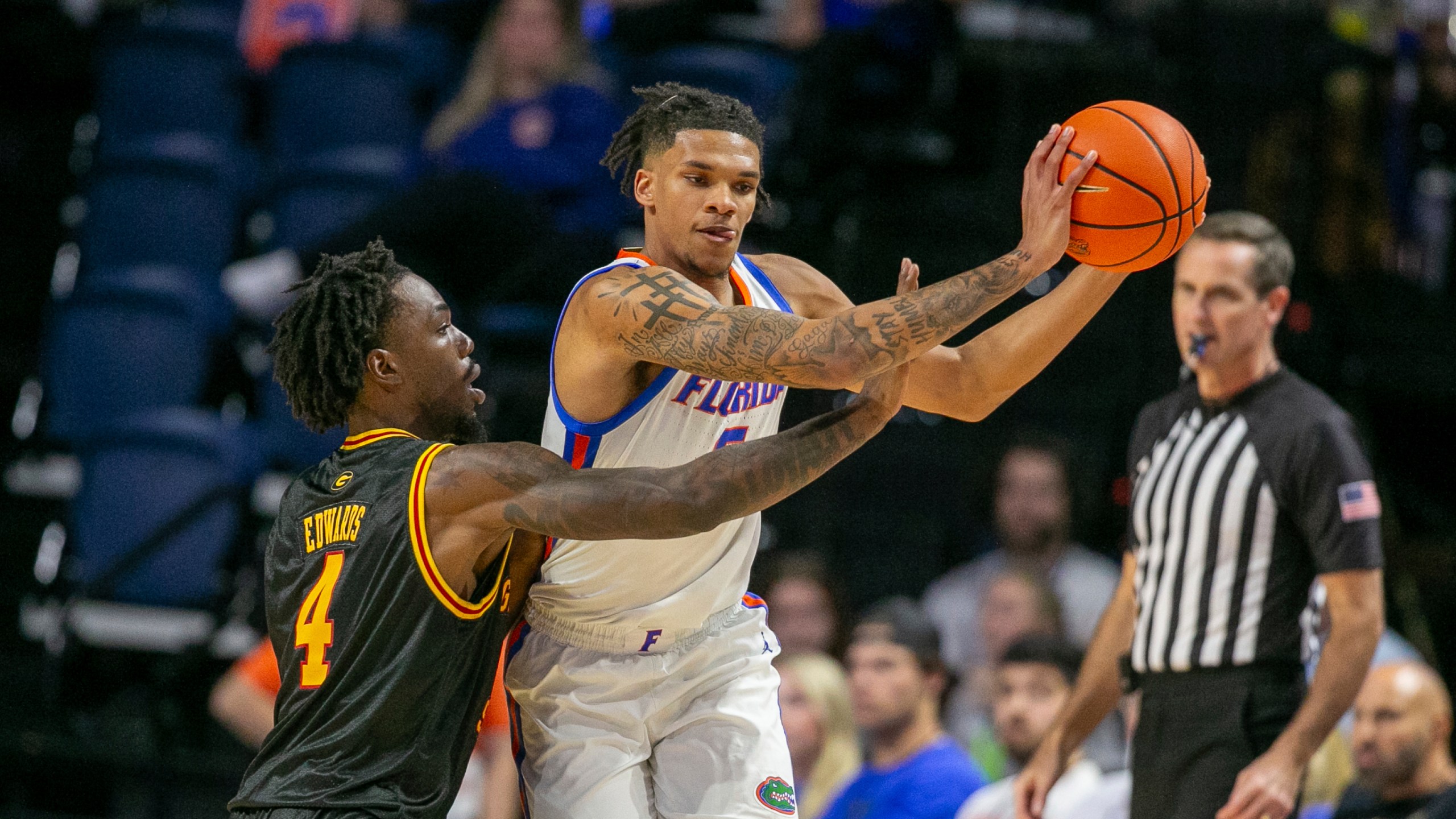 Grambling State guard P.J. Edwards (4) pressures Florida guard Will Richard, right, during the first half of an NCAA college basketball game, Monday, Nov. 11, 2024, in Gainesville, Fla. (AP Photo/Alan Youngblood)