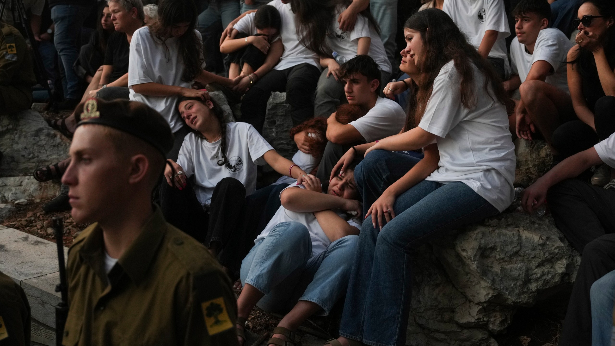 Mourners react during eulogies for Israeli soldier Capt. Itay Marcovich, who was killed in action in Lebanon, during his funeral in Kokhav Yair, Israel, Thursday, Nov. 14, 2024. (AP Photo/Ohad Zwigenberg)