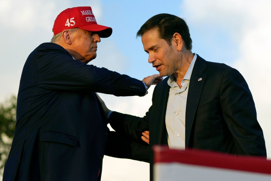 FILE - Then former President Donald Trump pats Sen. Marco Rubio, R-Fla., on the shoulder during a campaign rally at the Miami-Dade County Fair and Exposition in Miami, Nov. 6, 2022. (AP Photo/Rebecca Blackwell, File)