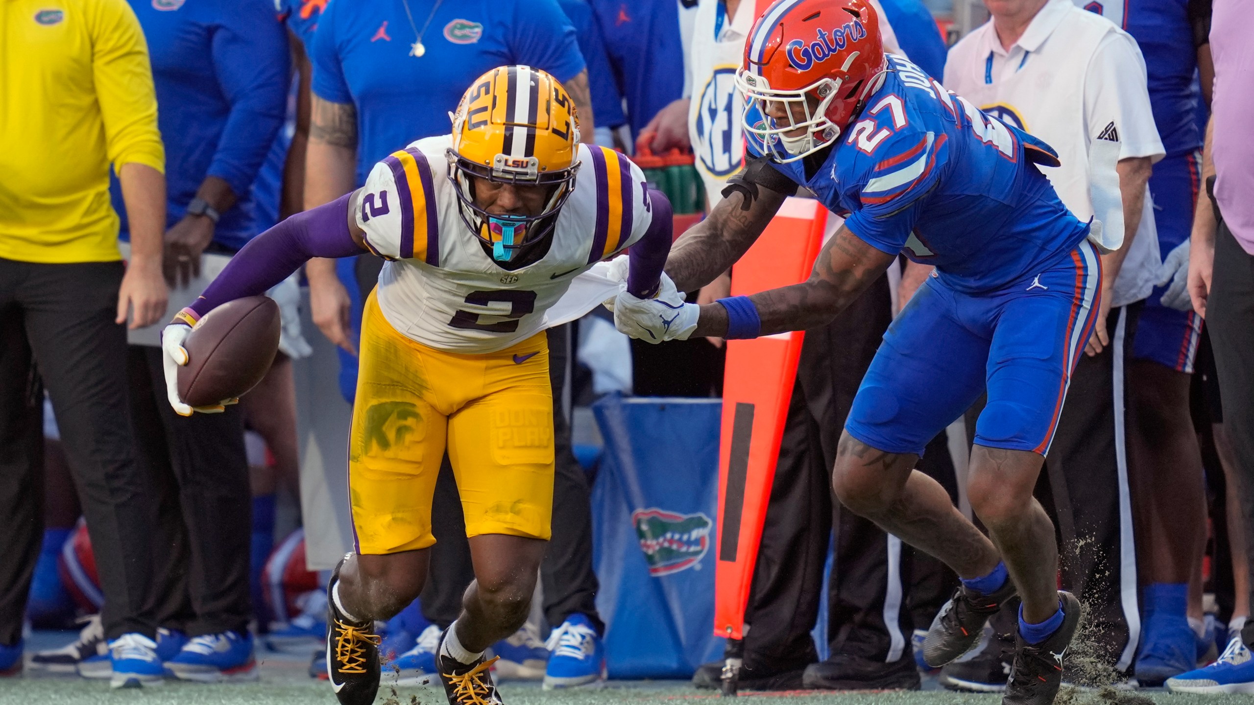 Florida defensive back Dijon Johnson (27) tries to stop LSU wide receiver Kyren Lacy (2) after a reception during the first half of an NCAA college football game, Saturday, Nov. 16, 2024, in Gainesville, Fla. (AP Photo/John Raoux)