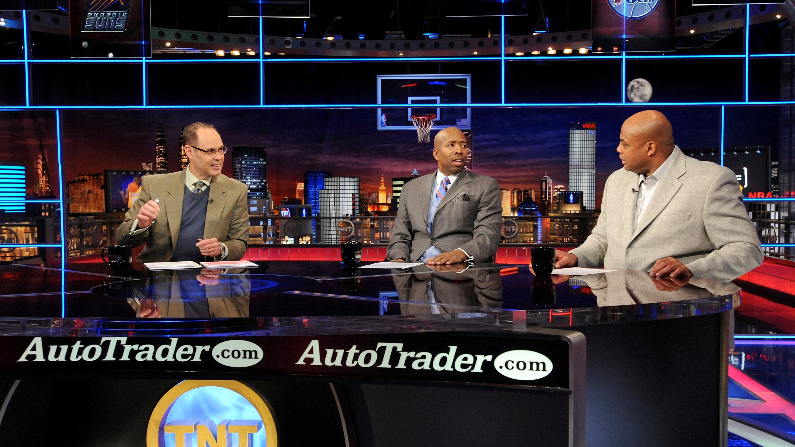 FILE - Inside the NBA host Ernie Johnson Jr., left, and analysts Kenny Smith, center, and Charles Barkley speak on the set at the TNT studios in Atlanta, Feb. 4, 2010. (AP Photo/Erik S. Lesser, File)