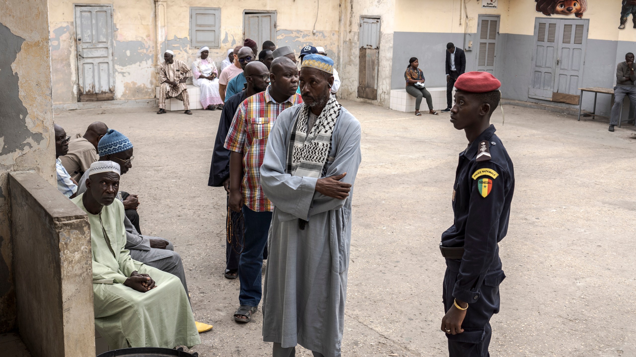 People wait to cast their ballot for legislative elections in Dakar, Senegal Sunday, Nov. 17, 2024. (AP Photo/Annika Hammerschlag)