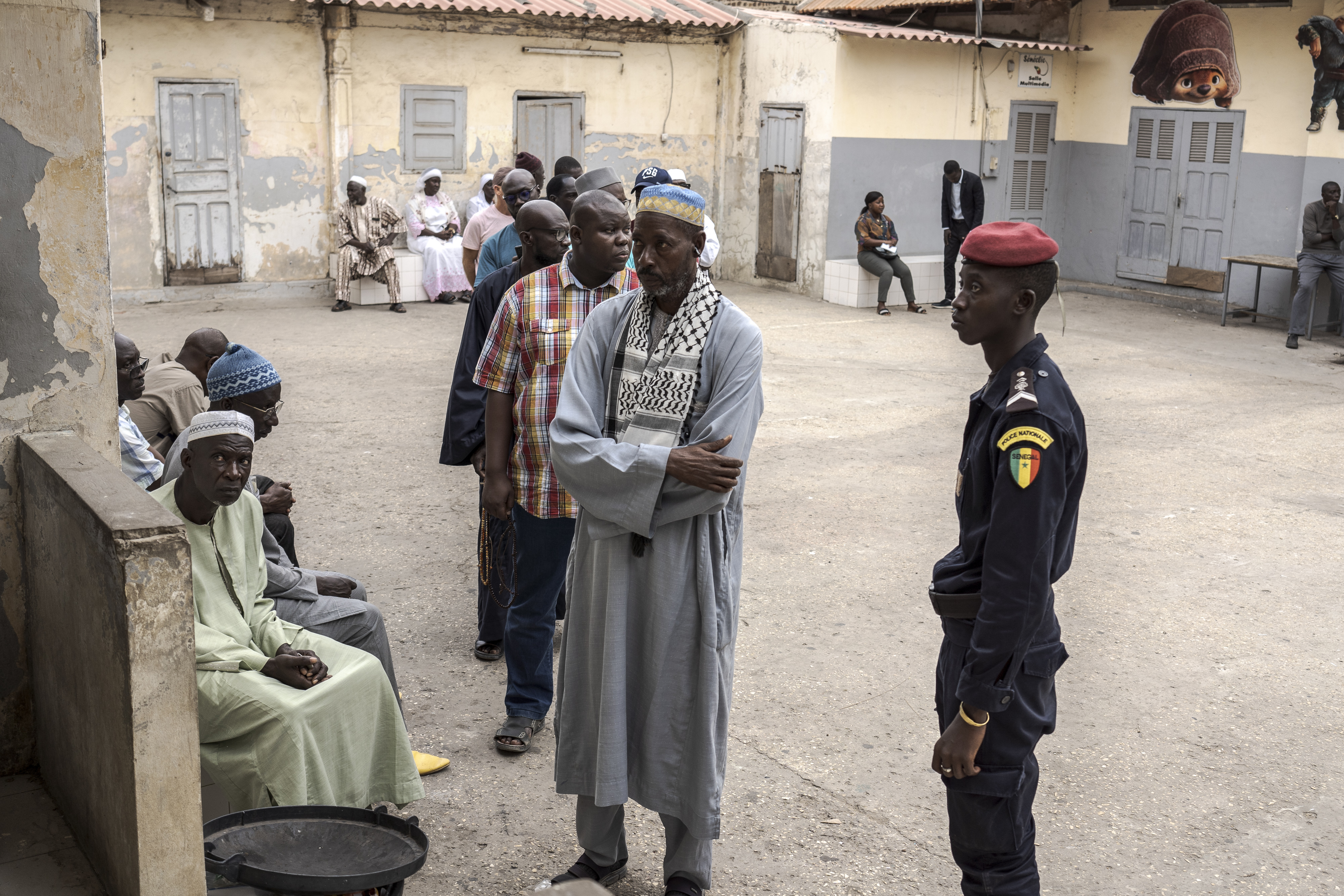 People wait to cast their ballot for legislative elections in Dakar, Senegal Sunday, Nov. 17, 2024. (AP Photo/Annika Hammerschlag)