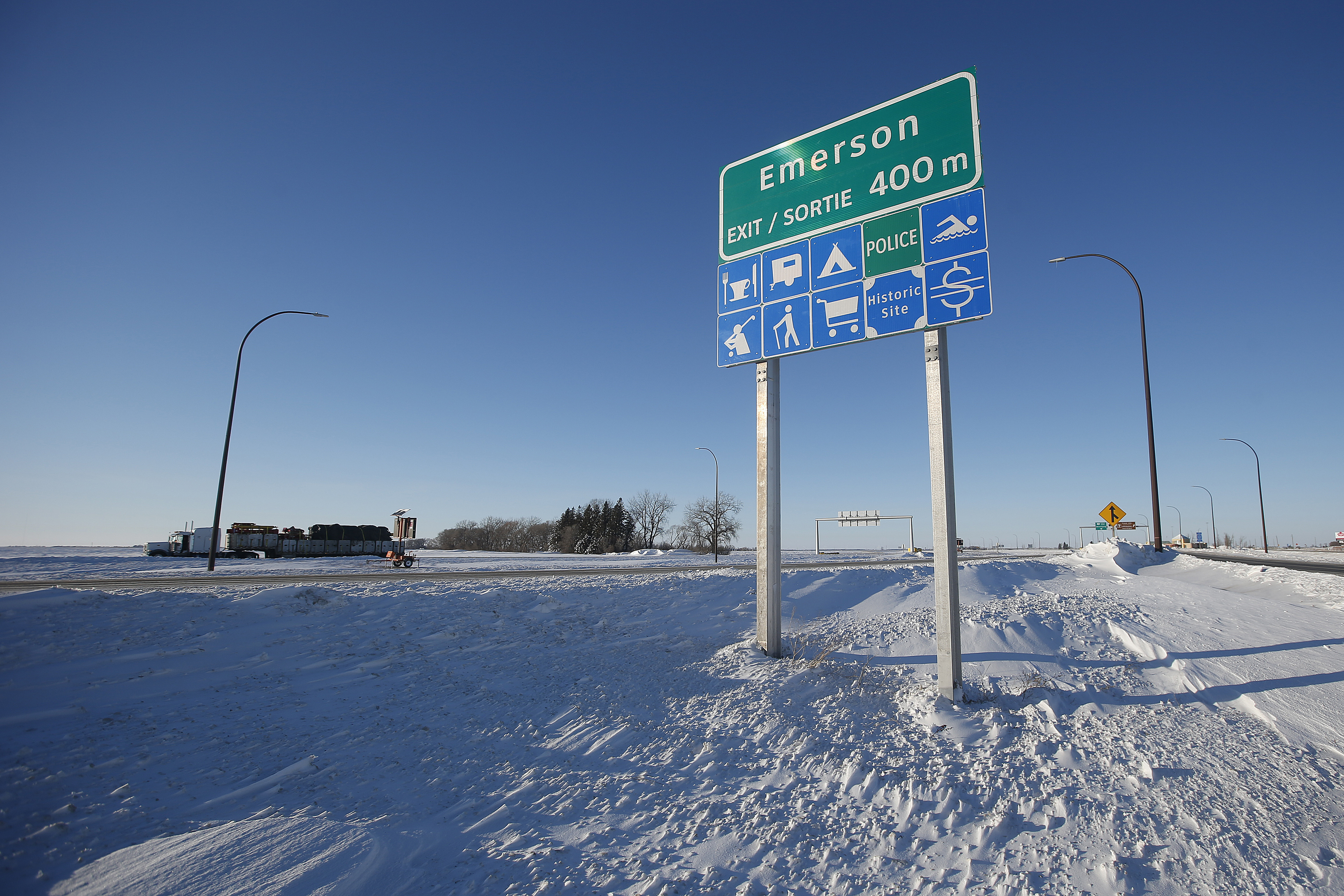 FILE - Road signage is posted just outside of Emerson, Manitoba on Thursday, Jan. 20, 2022. (John Woods/The Canadian Press via AP)