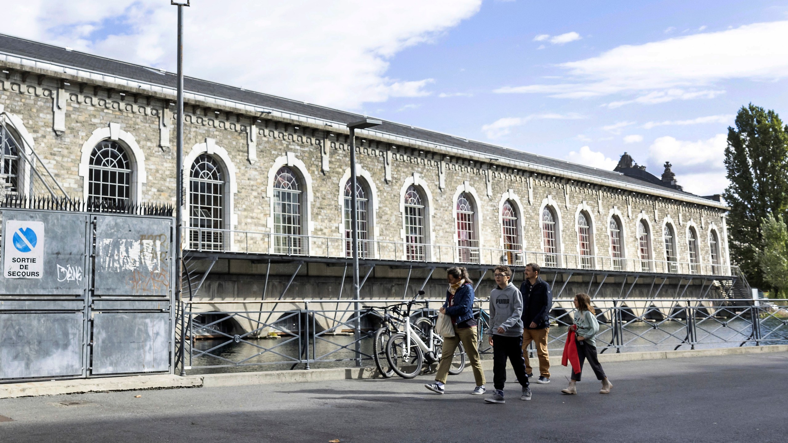 People walk past the "Batiment des Forces Motrices" in Geneva, Switzerland, Saturday, Sept. 10, 2022. (Salvatore Di Nolfi/Keystone via AP)