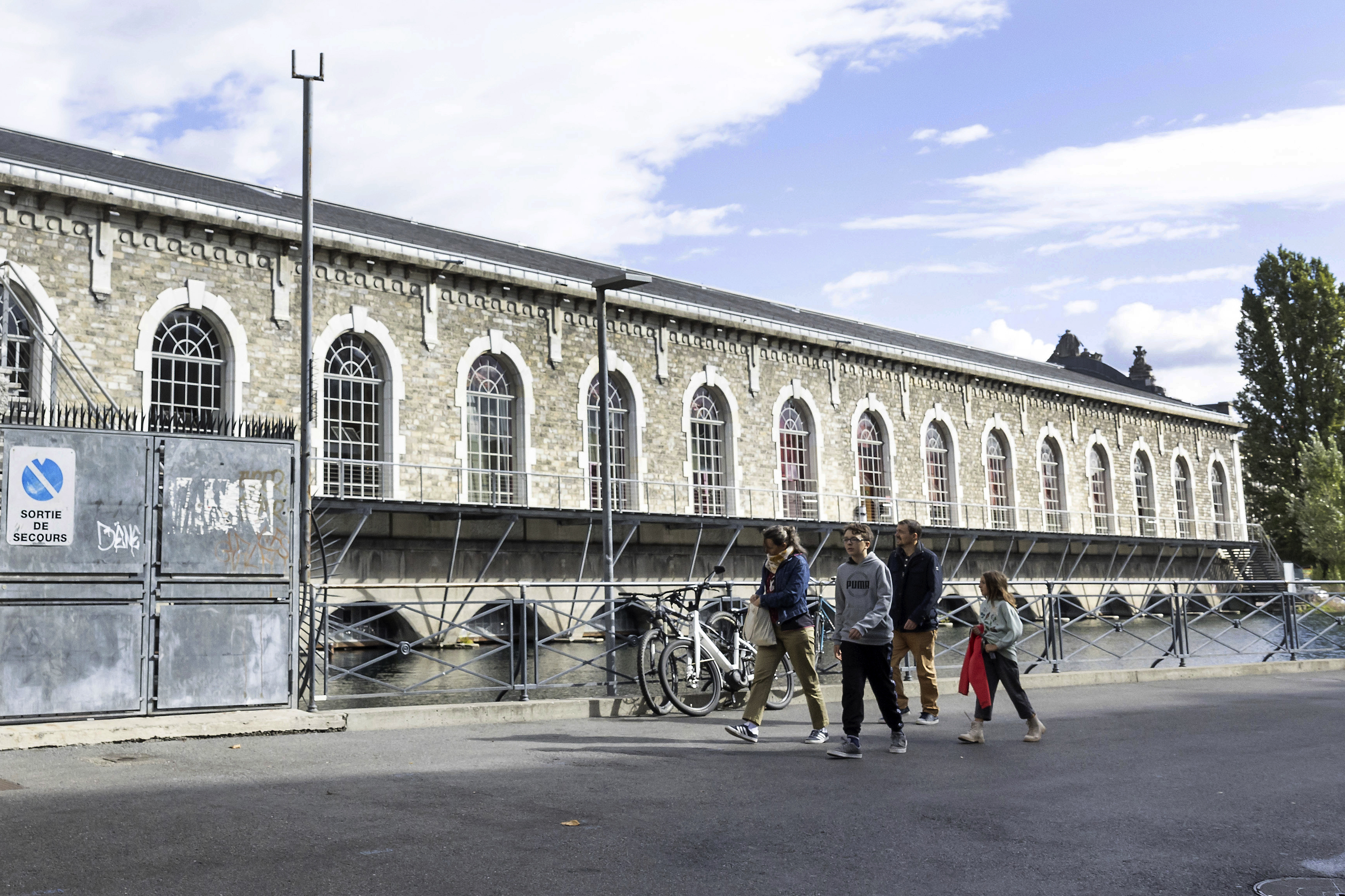 People walk past the "Batiment des Forces Motrices" in Geneva, Switzerland, Saturday, Sept. 10, 2022. (Salvatore Di Nolfi/Keystone via AP)