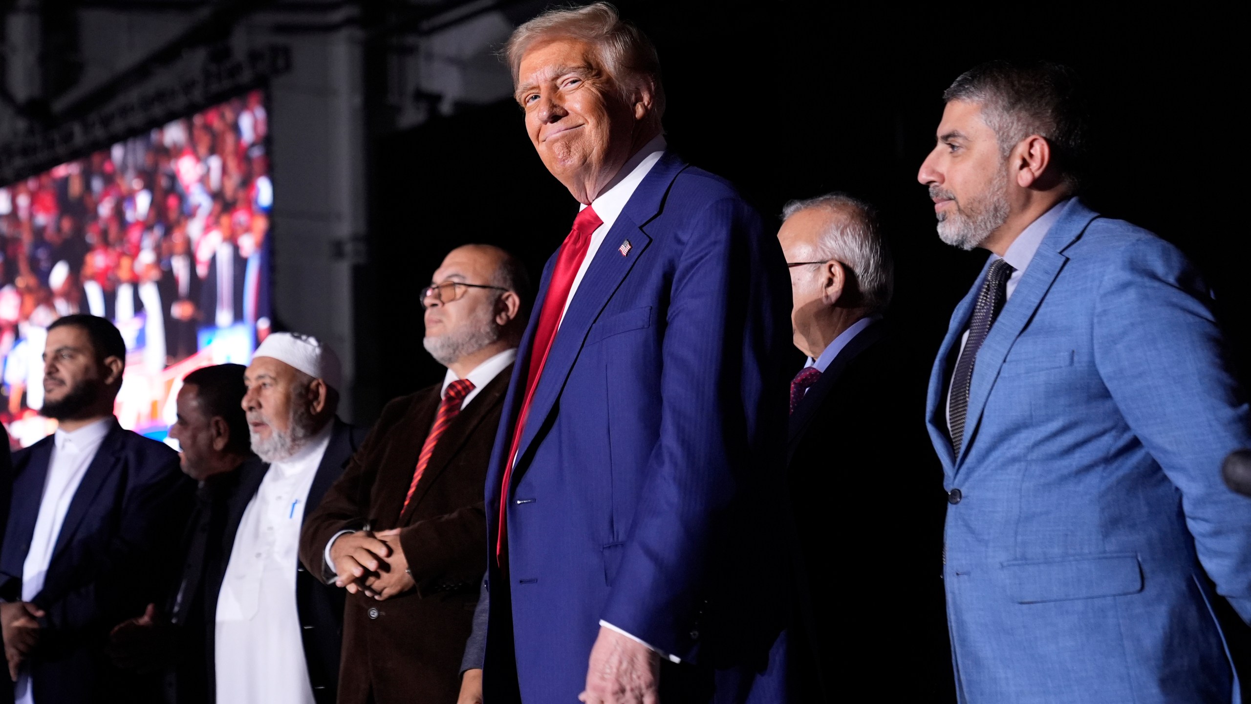 FILE - Republican presidential nominee former President Donald Trump, center, stands alongside local Muslim leaders during a campaign rally, Oct. 26, 2024, in Novi, Mich. (AP Photo/Alex Brandon, File)