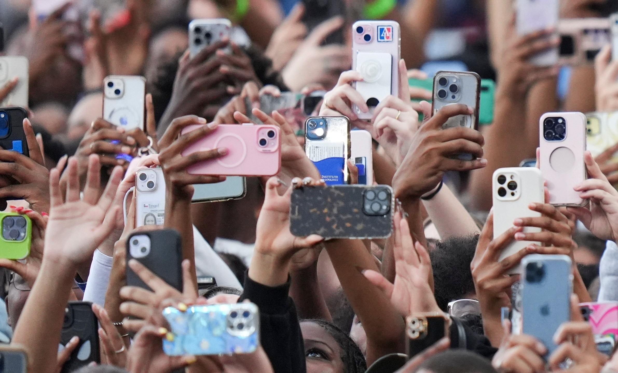 Supporters of Vice President Kamala Harris hold up their phones as she delivers a concession speech for the 2024 presidential election, Wednesday, Nov. 6, 2024, on the campus of Howard University in Washington. (AP Photo/Stephanie Scarbrough)