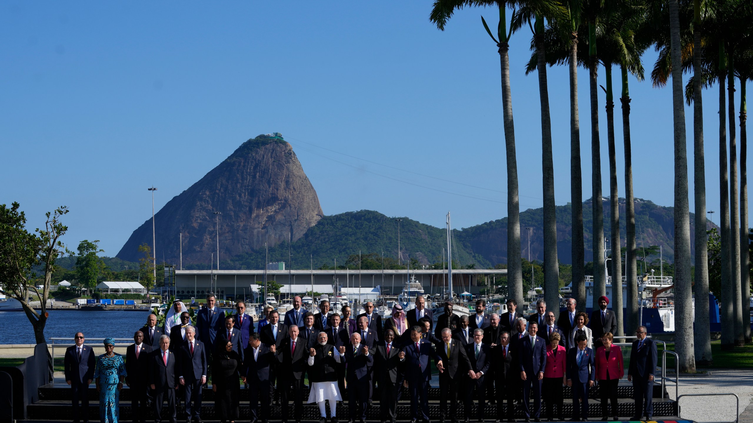 Backdropped by Sugar Loaf mountain, leaders attending the G20 Summit pose for a group photo in Rio de Janeiro, Monday, Nov. 18, 2024. (AP Photo/Eraldo Peres)