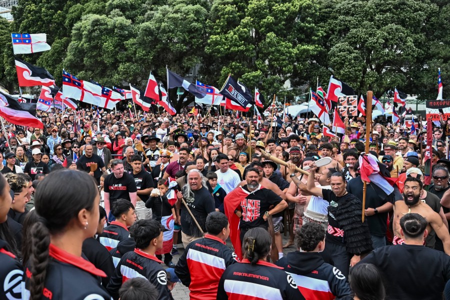 Thousands of people gather outside New Zealand's parliament to protest a proposed law that would redefine the country's founding agreement between Indigenous Māori and the British Crown, in Wellington Tuesday, Nov. 19, 2024. (AP Photo/Mark Tantrum)