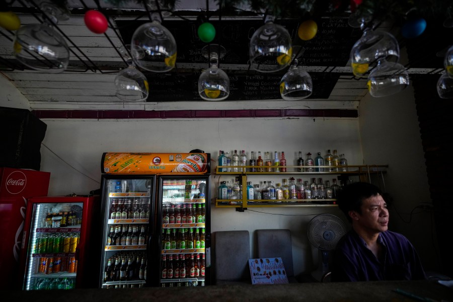 Duong Duc Toan, the manager of Nana Backpack hostel sits in the bar of the hostel in Vang Vieng, Laos, Tuesday, Nov. 19, 2024. (AP Photo/Anupam Nath)