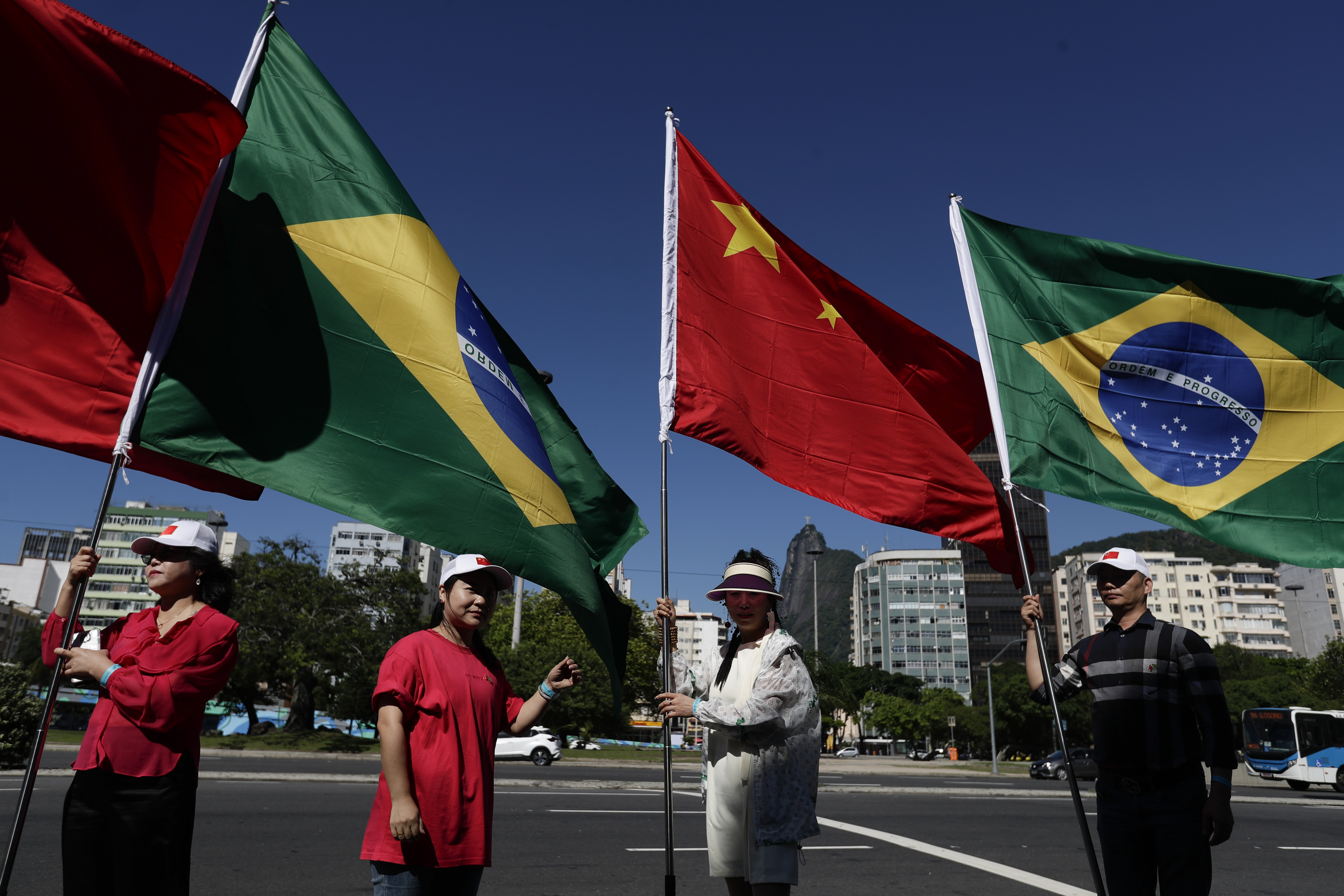 People hold Brazilian and Chinese flags during the G20 Summit in Rio de Janeiro, Monday, Nov. 18, 2024. (AP Photo/Bruna Prado)