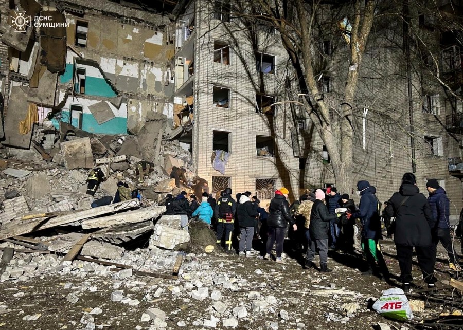 In this photo provided by the Ukrainian Emergency Services on Nov. 19, 2024, rescue workers and volunteers clear the rubble of a residential building destroyed by a Russian strike in Hlukhiv, Ukraine. (Ukrainian Emergency Service via AP)