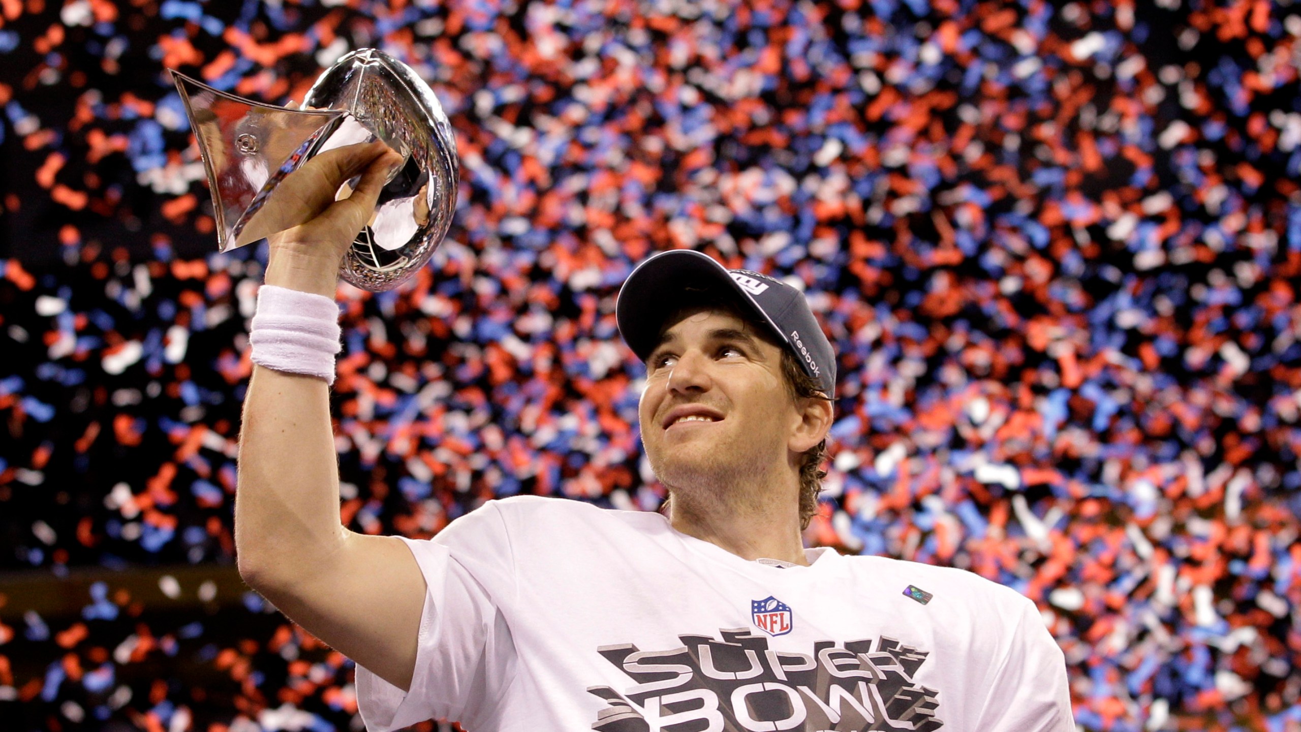 FILE - New York Giants quarterback Eli Manning holds up the Vince Lombardi Trophy while celebrating his team's 21-17 win over the New England Patriots in the NFL Super Bowl XLVI football game, Feb. 5, 2012, in Indianapolis. (AP Photo/David J. Phillip, File)