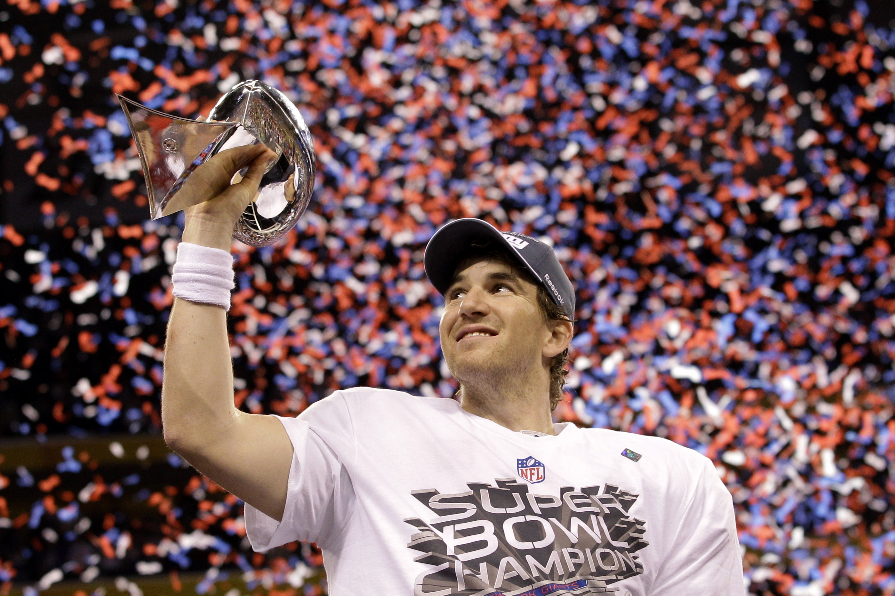 FILE - New York Giants quarterback Eli Manning holds up the Vince Lombardi Trophy while celebrating his team's 21-17 win over the New England Patriots in the NFL Super Bowl XLVI football game, Feb. 5, 2012, in Indianapolis. (AP Photo/David J. Phillip, File)