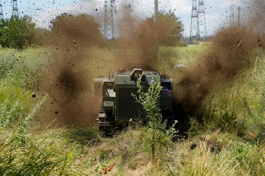 FILE - A Russian military robotic vehicle detonates a land mine on a mine clearing mission to defuse mines along the high voltage line in Mariupol, on the territory which is under the Government of the Donetsk People's Republic control, eastern Ukraine, July 13, 2022. This photo was taken during a trip organized by the Russian Ministry of Defense. (AP Photo, File)