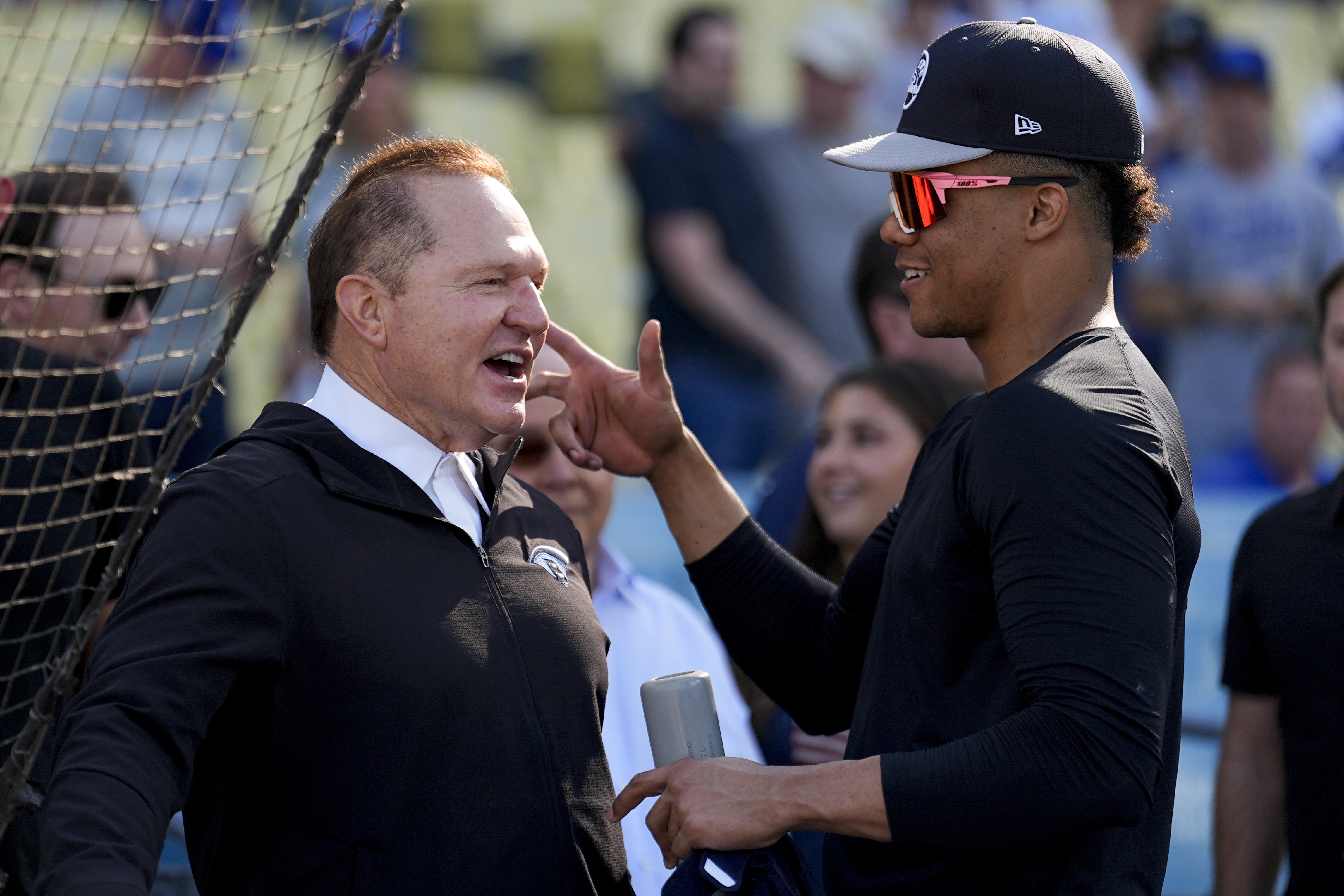 New York Yankees' Juan Soto talks with agent Scott Boras before Game 1 of the baseball World Series against the Los Angeles Dodgers, Friday, Oct. 25, 2024, in Los Angeles. (AP Photo/Julio Cortez)