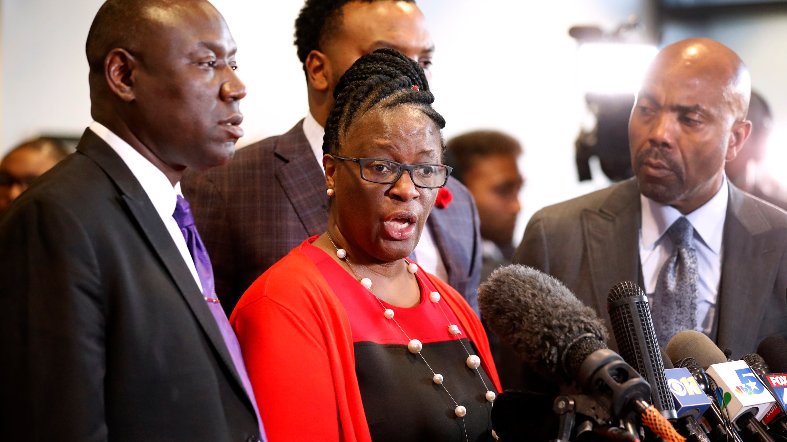 FILE - Allison Jean, center, mother of Botham Jean, makes comments during a news conference as attorneys Ben Crump, left, Lee Merritt, rear, and Daryl Washington, right, look on after the sentencing phase of former Dallas police officer Amber Guyger's murder trial at Frank Crowley Court Building in Dallas, Oct. 2, 2019. (AP Photo/Tony Gutierrez, File)