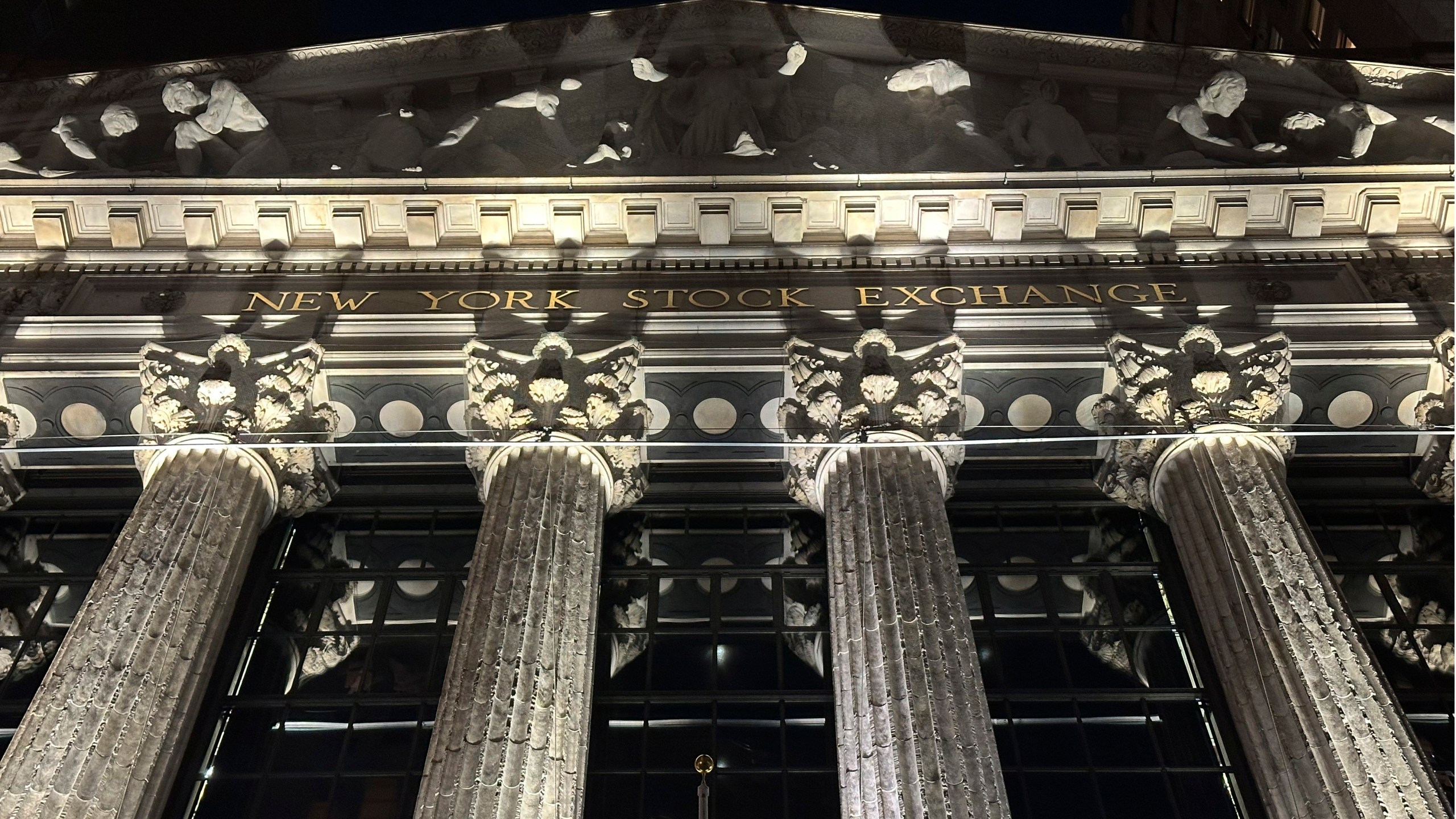 The facade of the New York Stock Exchange is illuminated on Tuesday, Nov. 19, 2024. (AP Photo/Peter Morgan)