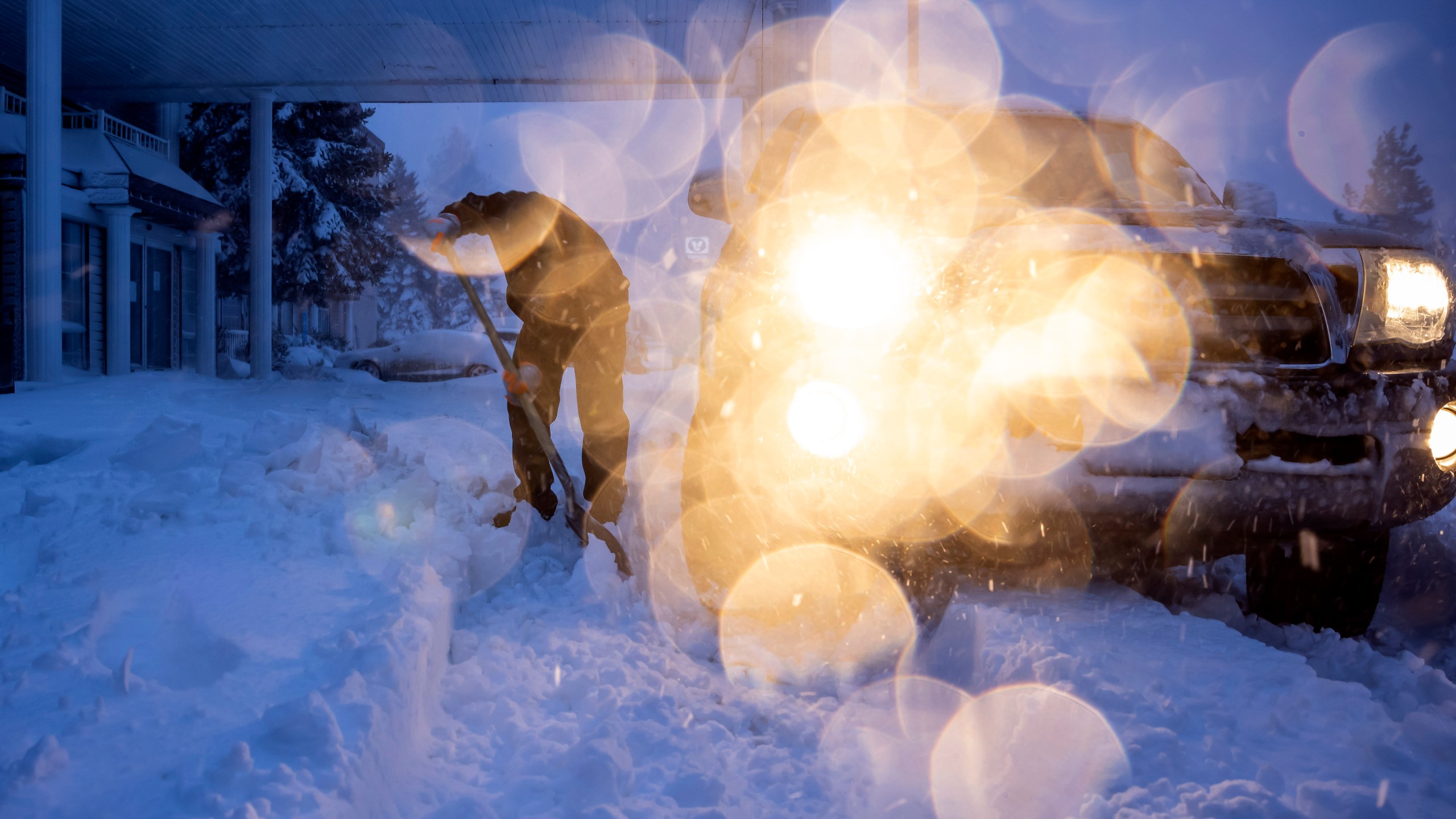 Daniel Sandoval tries to dig out his truck that got stuck in snow after dropping off his daughter at work in Weed, Calif., Wednesday, Nov. 20, 2024. (Carlos Avila Gonzalez/San Francisco Chronicle via AP)